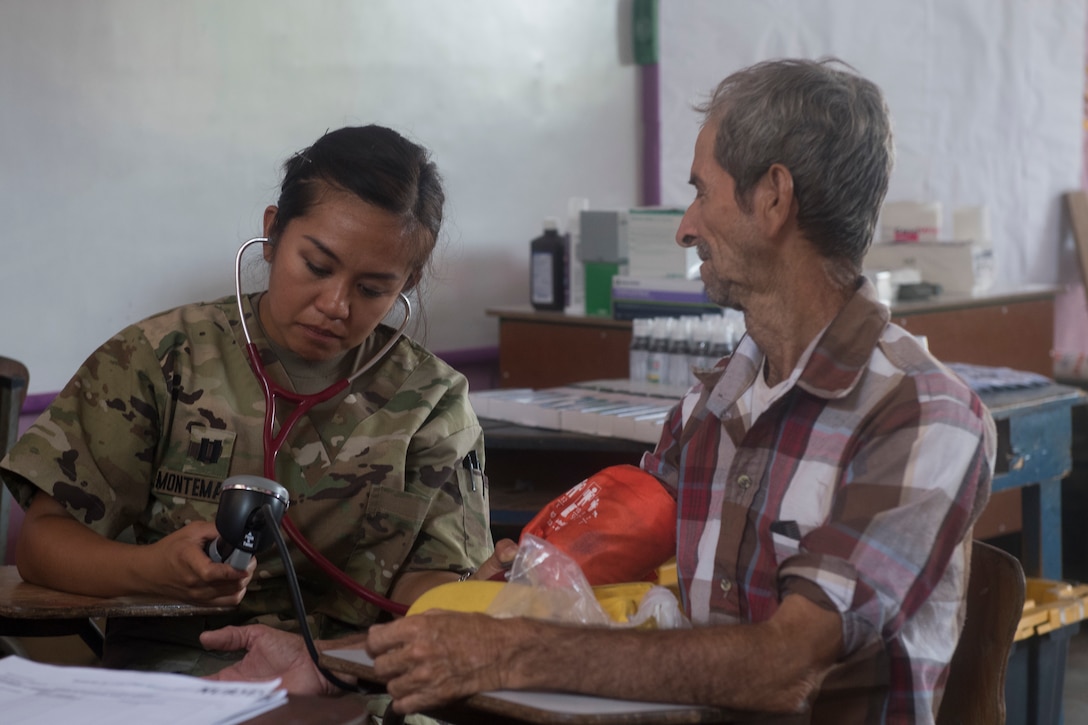 U.S. Army Capt. Allyssa Montemayor, Joint Task Force – Bravo Medical Element registered nurse, takes a blood pressure measurement as part of a medical screening during a Medical Readiness Training Exercise (MEDRETE), May 9, 2019, in El Paraiso, Honduras. Members of JTF-B partnered with the Honduran Military and Ministry of Health to provide health care services for more than 1,300 Honduran citizens; reaching a third of the citizens in the towns of Argelia, Santa Maria and Las Dificultades in the El Paraiso Department. The goal of the mission was to provide the medical staff training in their areas of expertise as well as strengthen partnerships with Honduran allies. (U.S. Air Force photo by Staff Sgt. Eric Summers Jr.)