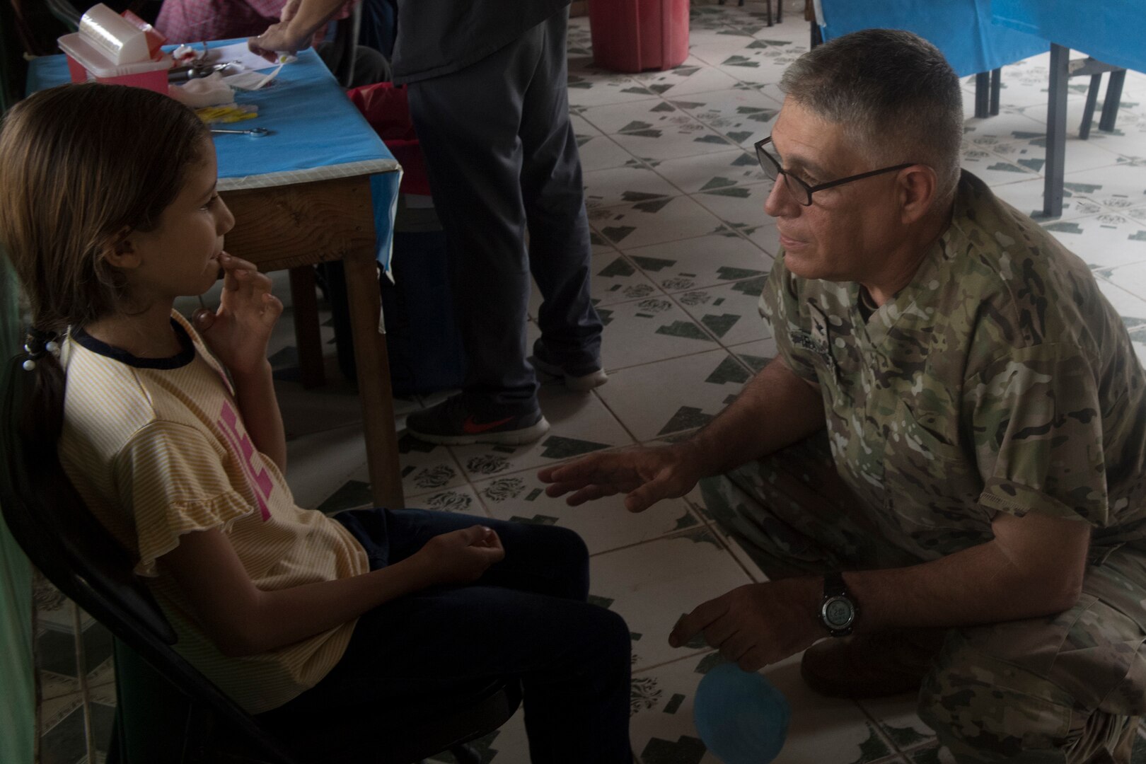 U.S. Army Col. Manuel Iravedra, Joint Task Force – Bravo Medical Element dentist, consoles a young child during a dental examination as part of a Medical Readiness Training Exercise (MEDRETE) May 10, 2019, in El Paraiso, Honduras. Members of JTF-B partnered with the Honduran Military and Ministry of Health to provide health care services for more than 1,300 Honduran citizens; reaching a third of the citizens in the towns of Argelia, Santa Maria and Las Dificultades in the El Paraiso Department. The goal of the mission was to provide the medical staff training in their areas of expertise as well as strengthen partnerships with the Honduran allies. (U.S. Air Force photo by Staff Sgt. Eric Summers Jr.)