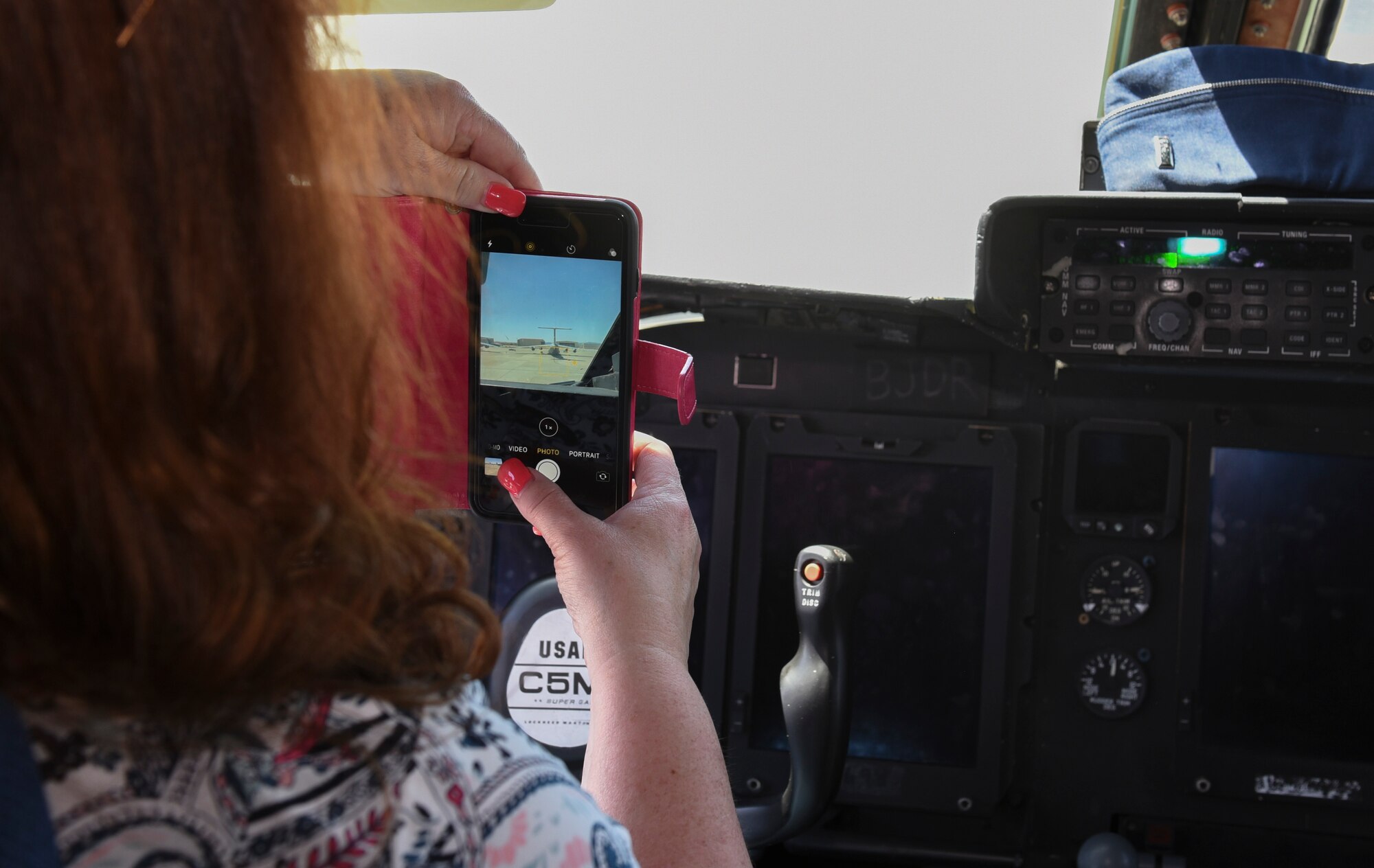 Stephanie Knight, Leadership Today course tour participant, photographs a C-17 Globemaster lll May 2, 2019 at Travis Air Force Base, California. The program is designed to develop knowledgeable, skilled, committed and active future leaders in the community. (U.S. Air Force photo by Airman 1st Class Cameron Otte)
