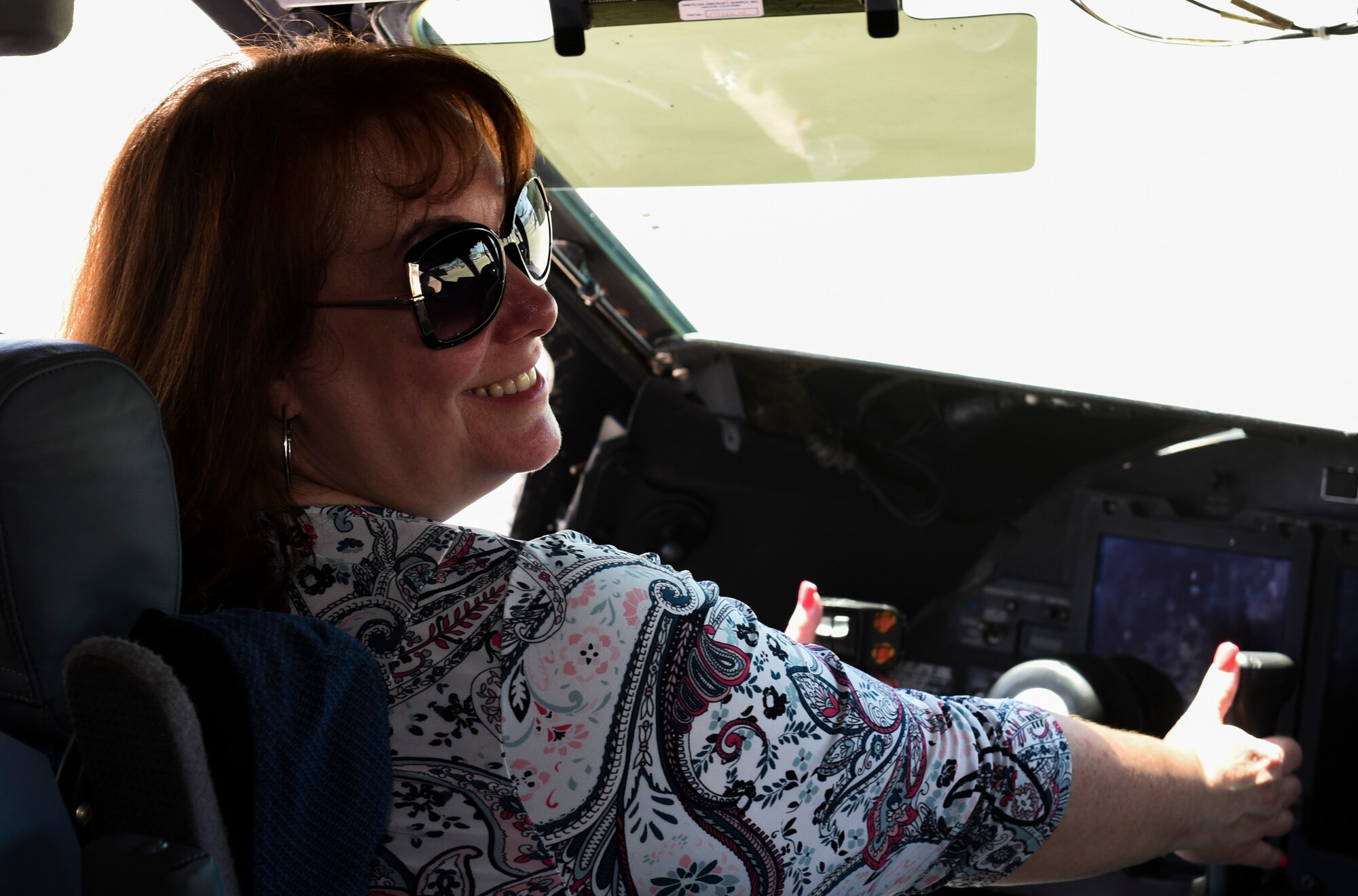 Stephanie Knight, Leadership Today course tour participant, sits in the cockpit of a C-17 Globemaster lll May 2, 2019 at Travis Air Force Base, California. The program is designed to develop knowledgeable, skilled, committed and active future leaders in the community. (U.S. Air Force photo by Airman 1st Class Cameron Otte)