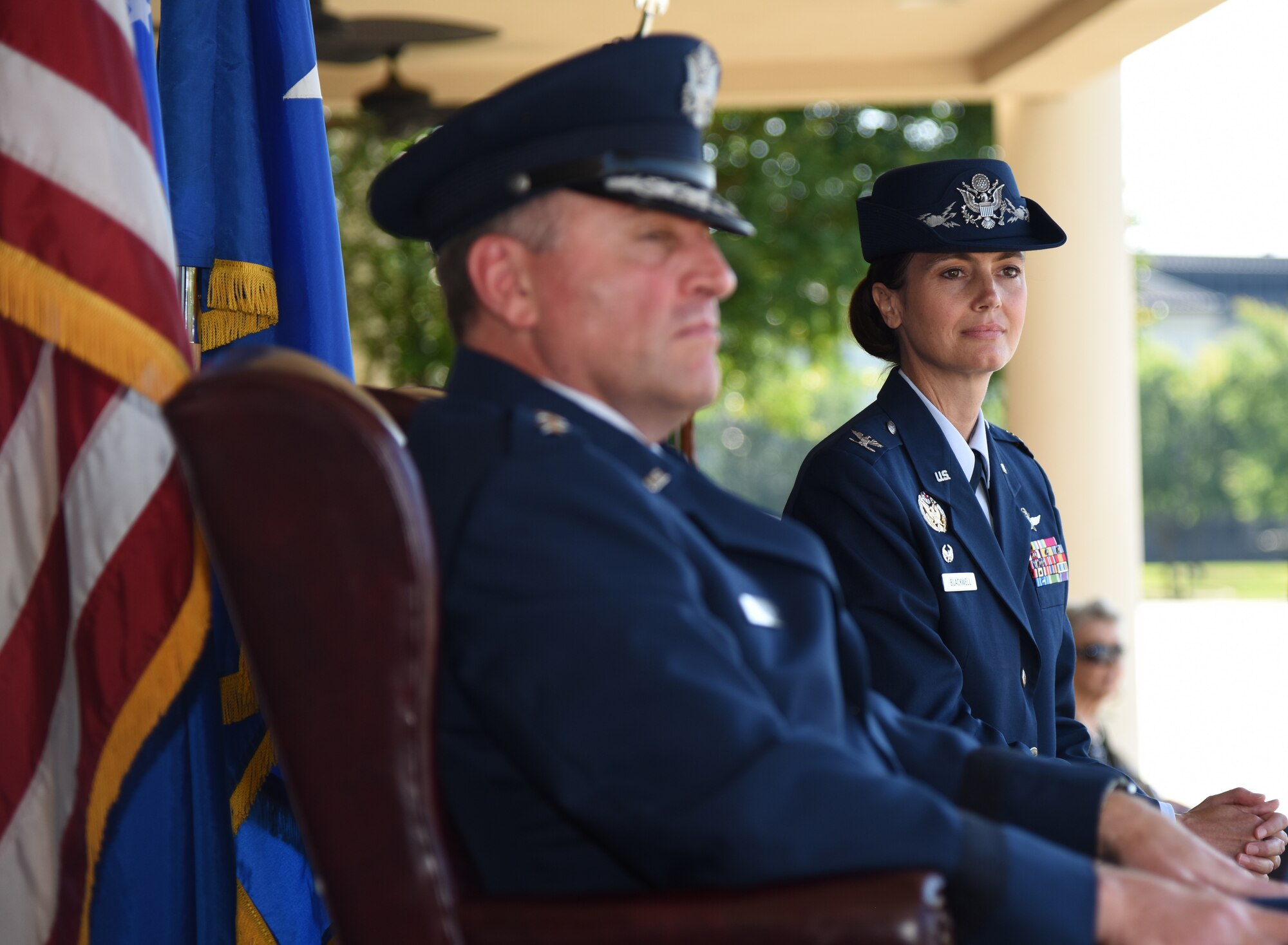 U.S. Air Force Maj. Gen. Timothy Leahy, Second Air Force commander, and Col. Heather Blackwell, incoming 81st Training Wing commander, look on as Col. Debra Lovette, outgoing 81st TRW commander, delivers her speech during the 81st TRW change of command ceremony on the Levitow Training Support Facility drill pad at Keesler Air Force Base, Mississippi, May 16, 2019. Blackwell assumed command from Col. Debra Lovette. (U.S. Air Force photo by Kemberly Groue)