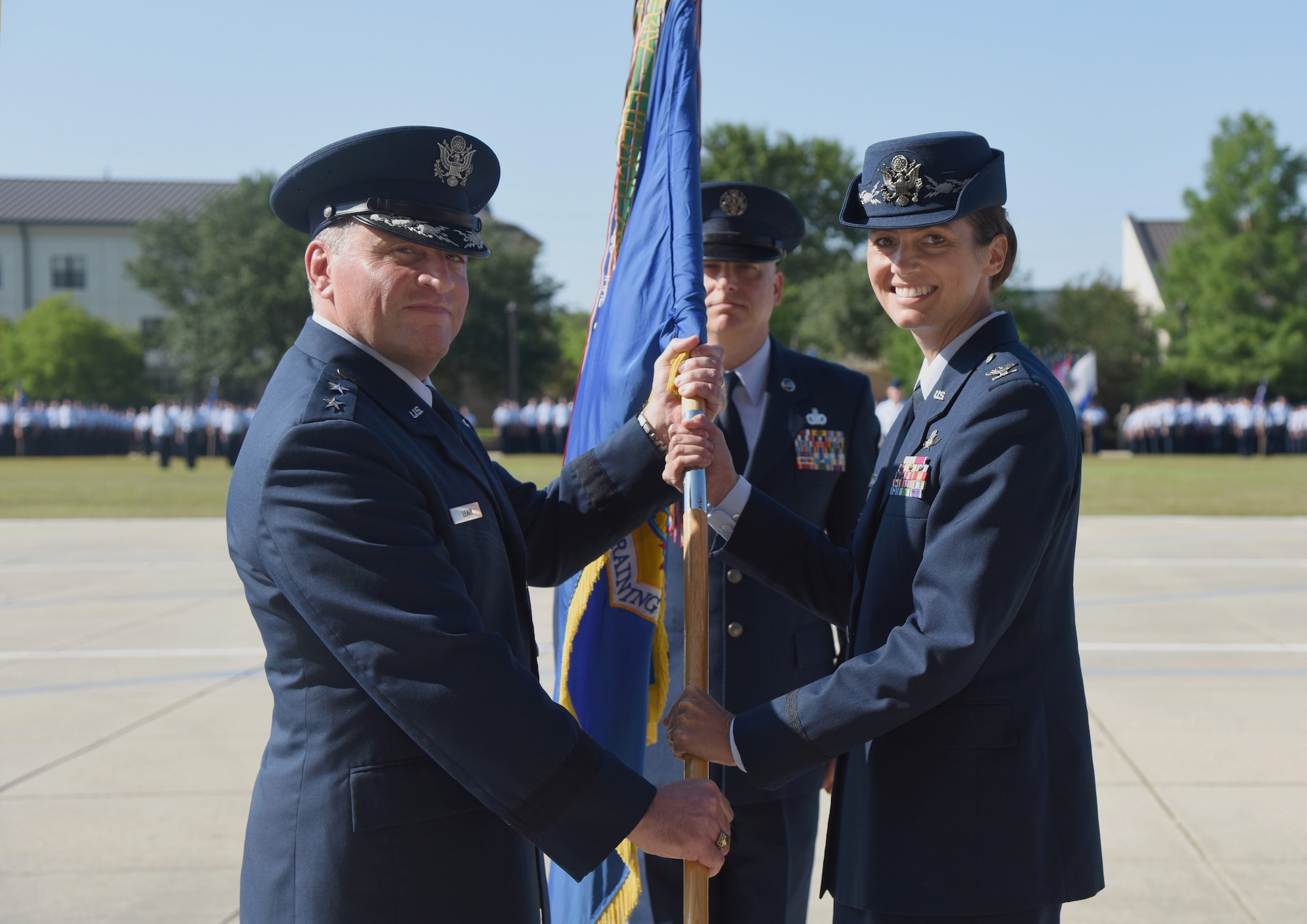 U.S. Air Force Maj. Gen. Timothy Leahy, Second Air Force commander, passes the guidon to Col. Heather Blackwell, 81st Training Wing commander, during a change of command ceremony at the Levitow Training Support Facility drill pad at Keesler Air Force Base, Mississippi, May 16, 2019. The ceremony is a symbol of command being exchanged from one commander to the next. Blackwell assumed command of the 81st TRW from Col. Debra Lovette. (U.S. Air Force photo by Kemberly Groue)