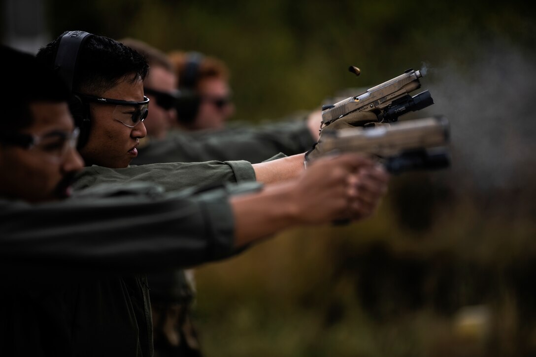 Cpl. Jeremy Chow, a Marine Corps Air Station Miramar Special Reactions Team (SRT) member, fires the M1911 Service Pistol during training at MCAS Miramar, Calif., May 15. The Marines conducted this training to hone their skills in close quarters combat and further familiarize themselves with the M1911. (U.S. Marine Corps photo by Sgt. Jake McClung)