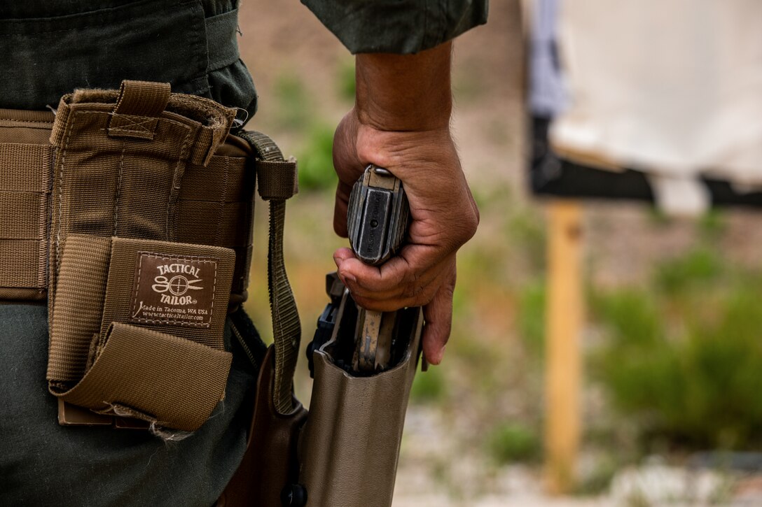 Cpl. Nicolas Raubolt, a Marine Corps Air Station Miramar Special Reactions Team member, holsters his M1911 Service Pistol during training at MCAS Miramar, Calif., May 15. The Marines conducted this training to hone their skills in close quarters combat and further familiarize themselves with the M1911. (U.S. Marine Corps photo by Sgt. Jake McClung)