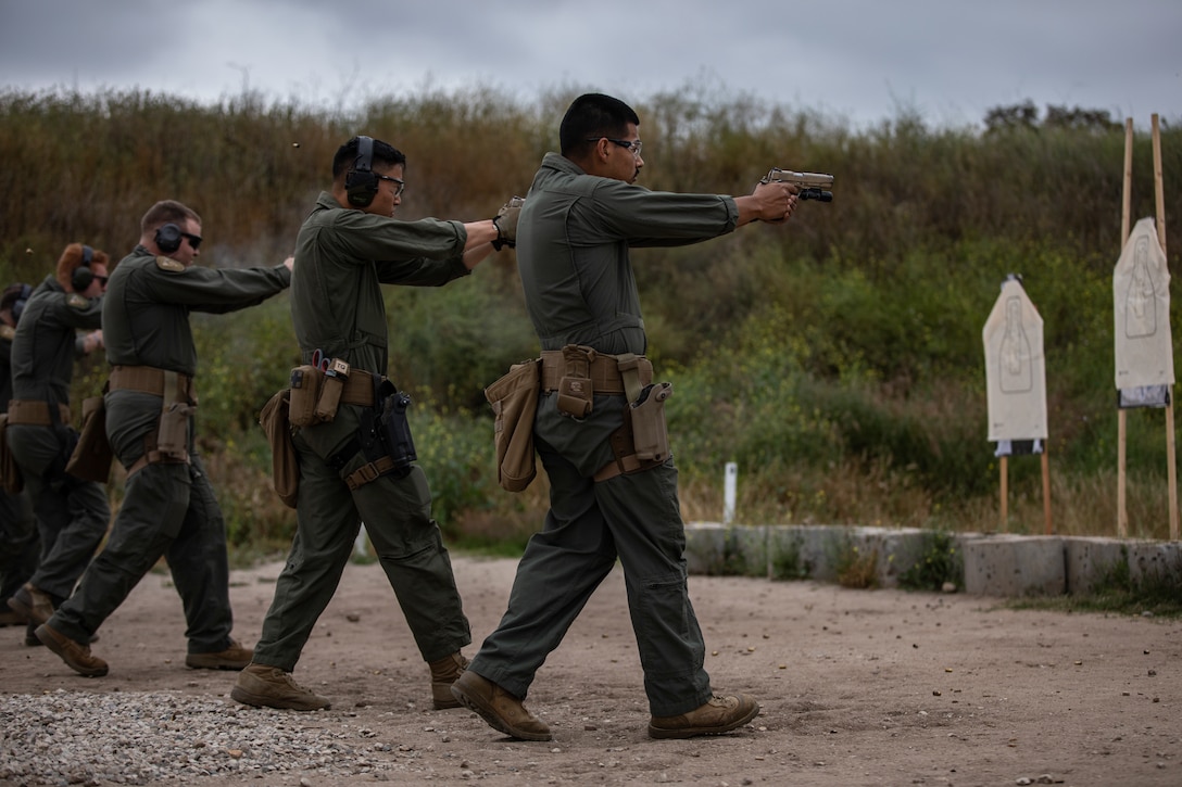 Marines with the Marine Corps Air Station Miramar Special Reactions Team (SRT) fire the M1911 Service Pistol during training at MCAS Miramar, Calif., May 15. The Marines conducted this training to hone their skills in close quarters combat and further familiarize themselves with the M1911. (U.S. Marine Corps photo by Sgt. Jake McClung)
