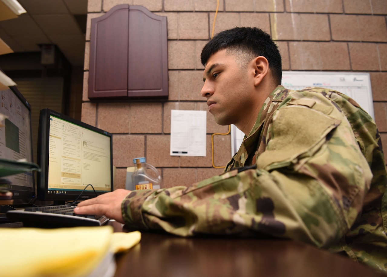 A man operates a laptop computer.