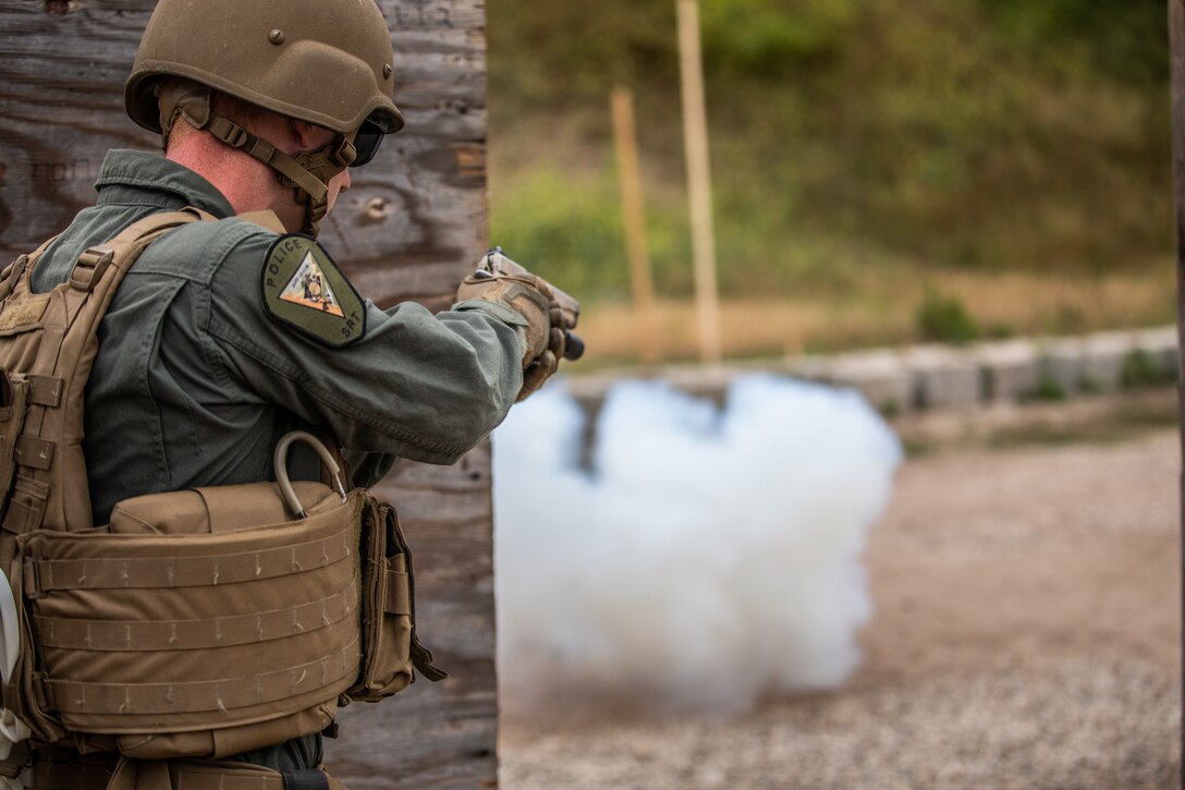 A Marine Corps Air Station Miramar Special Reactions Team (SRT) member prepares to clear an area after throwing a flash bang grenade during training at MCAS Miramar, Calif., May 15. The Marines conducted this training to hone their skills in close quarters combat and further familiarize themselves with the M1911 Service Pistol. (U.S. Marine Corps photo by Sgt. Jake McClung)