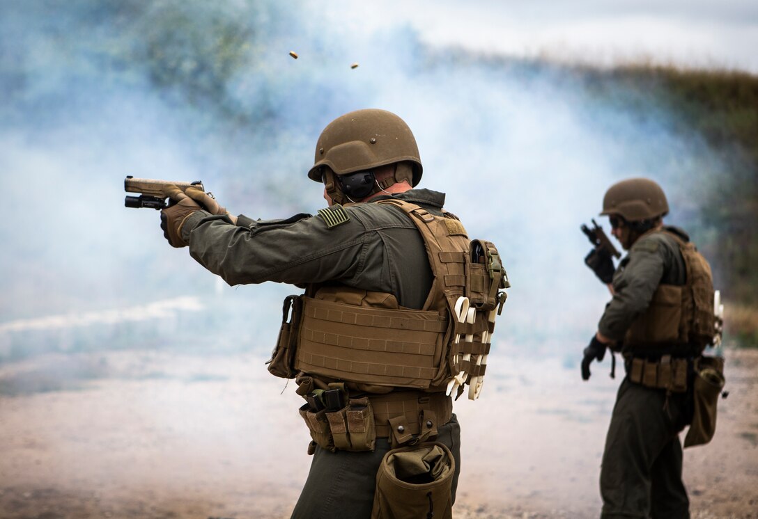 Marines with the Marine Corps Air Station Miramar Special Reactions Team (SRT) fire the M1911 Service Pistol during training at MCAS Miramar, Calif., May 15. The Marines conducted this training to hone their skills in close quarters combat and further familiarize themselves with the M1911. (U.S. Marine Corps photo by Sgt. Becky Cleveland)