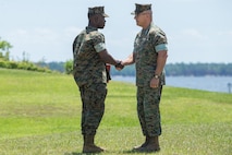 U.S. Marine Corps Lt. Gen. Robert F. Hedelund, right, commanding general of II Marine Expeditionary Force, shakes hands with Cpl. Lance F. Sumo, 2nd Supply Battalion, Combat Logistics Regiment 25, 2nd Marine Logistics Group, during an award ceremony at Camp Lejeune, North Carolina, May 14, 2019. During the ceremony, annual awards were presented to Marines and Sailors who displayed exceptional work ethic and leadership qualities.