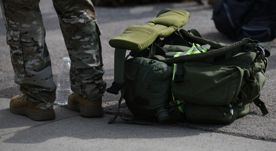 An Airman stands beside his rucksack as he waits for it to be weighed during the Police Week Ruck Challenge at Heritage Lake on Ellsworth Air Force Base, S.D., May 13, 2019. Participants had the option of filling their rucksacks with canned goods that were donated to Feeding South Dakota. Feeding South Dakota is an organization that provides food assistance to people throughout the state. (U.S. Air Force photo by Airman 1st Class Christina Bennett)