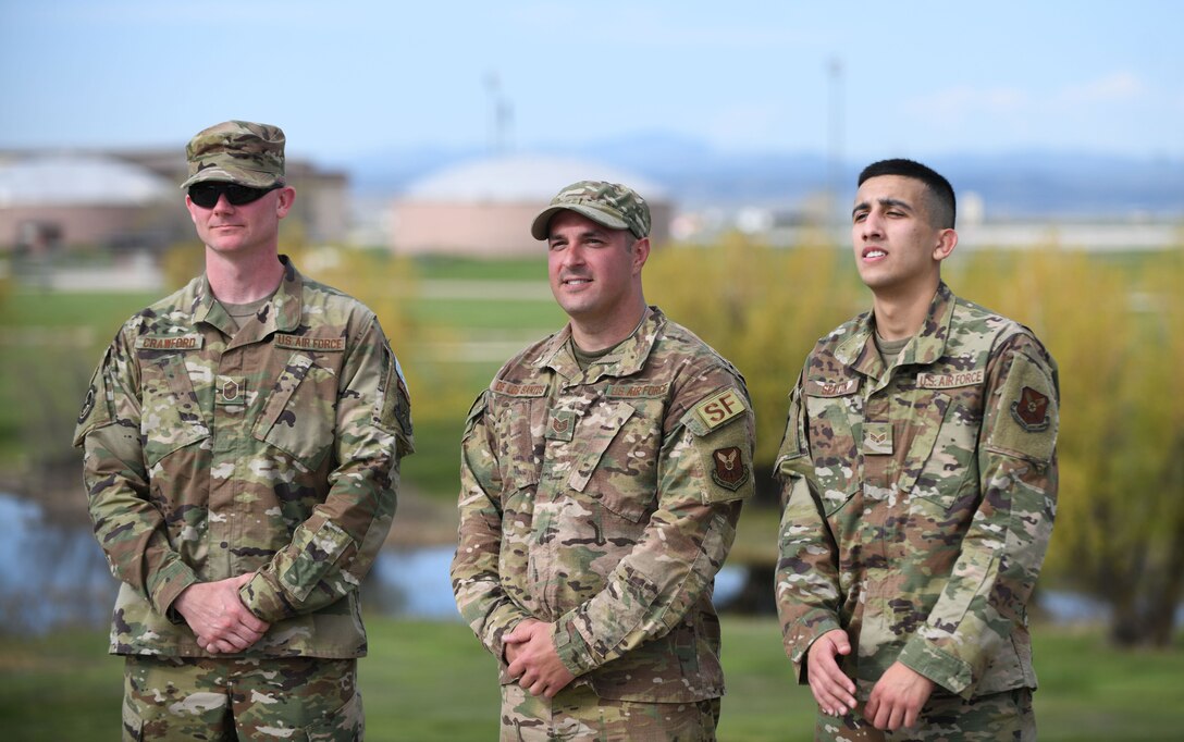 Senior Master Sgt. Michael Crawford, a 28th Security Forces Squadron operations superintendent, stands alongside Tech. Sgt. Jason De Los Santos, a 28th SFS noncommissioned officer in charge of physical security, and Senior Airman Michael Sexton, a 28th Munitions Squadron munitions storage crew member, after they are announced as the winners of the Police Week Ruck Challenge held at Heritage Lake on Ellsworth Air Force Base, S.D., May 13, 2019. De Los Santos won first place with a time of 54:05, Crawford placed second and Sexton came in third. (U.S. Air Force Photo by Airman 1st Class Christina Bennett)