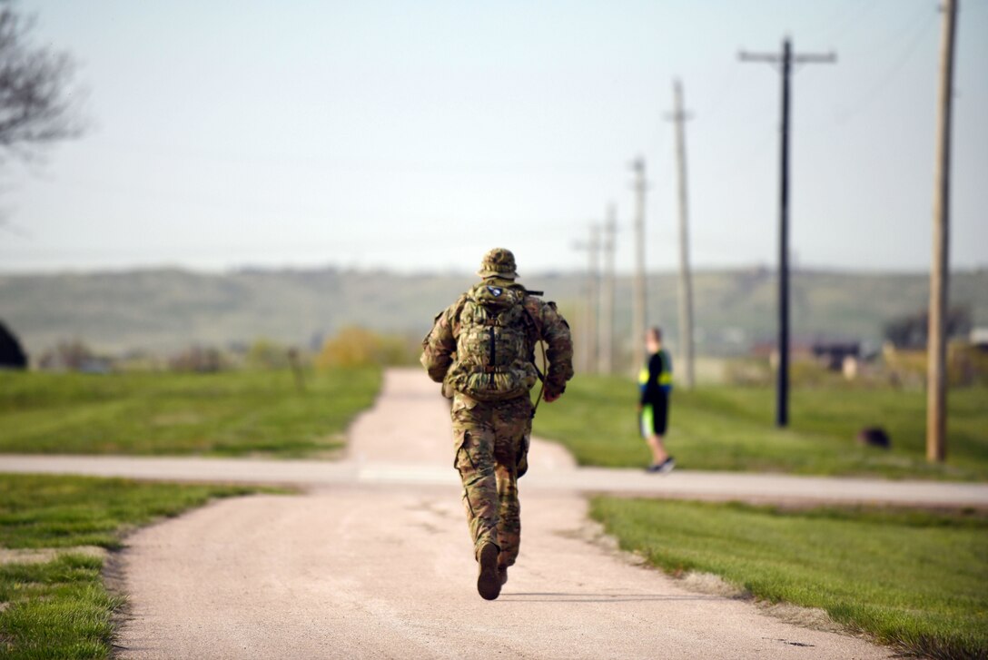 An Airman participates in the 4.5-mile Police Week Ruck Challenge at Heritage Lake on Ellsworth Air Force Base, S.D., May 13, 2019. The event was organized by the 28th Security Forces Squadron in honor of National Police Week. The week is dedicated to the countless numbers of law enforcement officers who have died while serving and protecting communities nationwide. (U.S. Air Force photo by Airman 1st Class Christina Bennett)