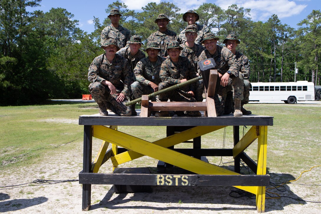 U.S. Marines and Sailors with 2nd Transportation Support Battalion, 2nd Marine Logistics Group (MLG), pose with a photo with their 1st place trophy after an awards ceremony at Camp Lejeune, North Carolina, May 15, 2019. Brig. Gen. Kevin J. Stewart, commanding officer of 2nd MLG, presented awards to the first, second, and third place winners of 2nd MLG's annual squad competition.