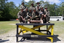 U.S. Marines and Sailors with 2nd Transportation Support Battalion, 2nd Marine Logistics Group (MLG), pose with a photo with their 1st place trophy after an awards ceremony at Camp Lejeune, North Carolina, May 15, 2019. Brig. Gen. Kevin J. Stewart, commanding officer of 2nd MLG, presented awards to the first, second, and third place winners of 2nd MLG's annual squad competition.