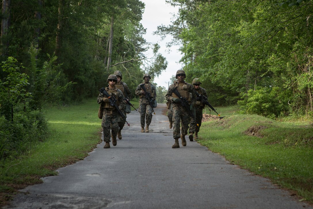 U.S. Marines and Sailors with Combat Logistics Regiment 2, 2nd Marine Logistics Group (MLG), patrol in formation during a squad competition at Camp Lejeune, North Carolina, May 14, 2019. The Marines and Sailors participated in 2nd MLG’s annual squad competition to test their combat skills and to maintain operational readiness.