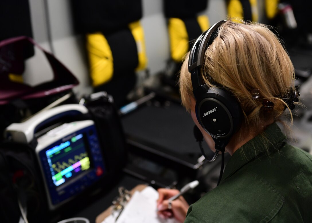 Staff Sgt. Lisa Zeng, medical technician with the 914th Aeromedical Evacuation Squadron, reads blood pressure readings over Honolulu, Hawaii April 24, 2019. The technicians had to use each other to practice as there were not any actual patients on board the plane for the training mission. (U.S. Air Force photo by Senior Airman Grace Thomson)