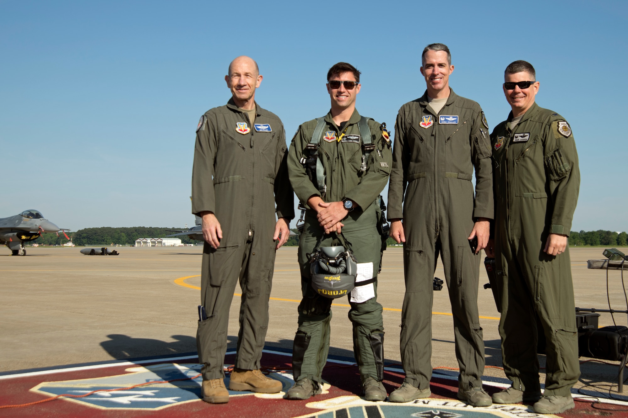 (From left) U.S. Air Force Gen. Mike Holmes, commander of Air Combat Command, Maj. Garret Schmitz, F-16 Viper Demonstration Team commander and pilot, Col. Derek O’Malley, 20th Fighter Wing commander, and Col. Brian Jackson, 20th Operations Group commander, stand for a photo at Joint Base Langley-Eustis, Va., May 16, 2019.