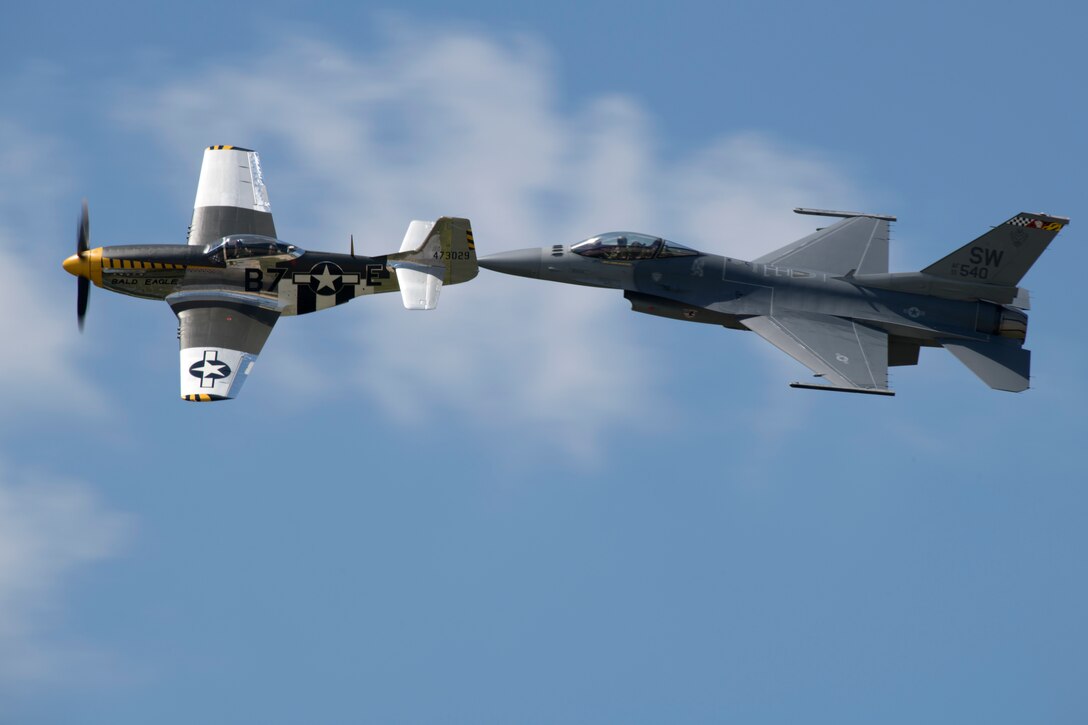 U.S. Air Force Maj. Garret Schmitz, F-16 Viper Demonstration Team commander and pilot, right, and Jim Beasley, Air Force Heritage Flight Foundation P-51 pilot, fly in formation during training at Joint Base Langley-Eustis, Va., May 16, 2019.