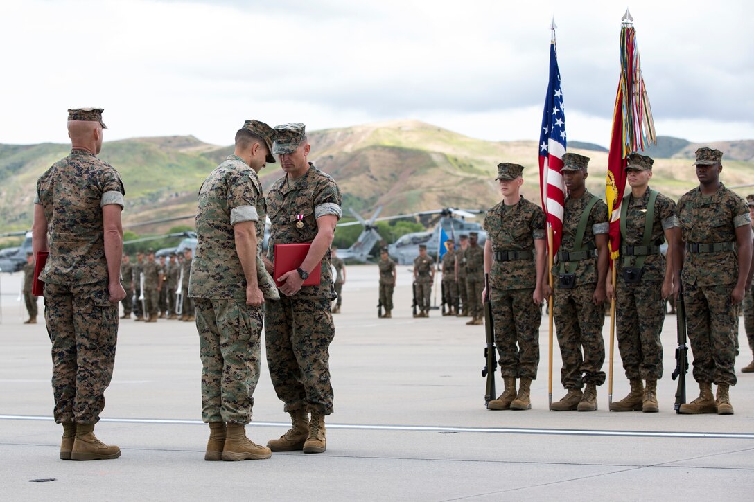 U.S. Marine Corp Lt. Col. Jeffrey Robb, commanding officer, Marine Light Attack Helicopter Squadron (HMLA) 369, awards Sgt. Maj. Michael R. Buckles the Meritorious Service Medal during a relief and appointment ceremony for HMLA-369 on Marine Corps Air Station Camp Pendleton, Calif., May 10, 2019. The ceremony formally recognized Buckles for his honorable service and dedication to the Corps and welcomed Sgt. Maj. Carey R. Wells as HMLA-369’s new sergeant major. (U.S. Marine Corps photo by Lance Cpl. Levi J. Guerra)