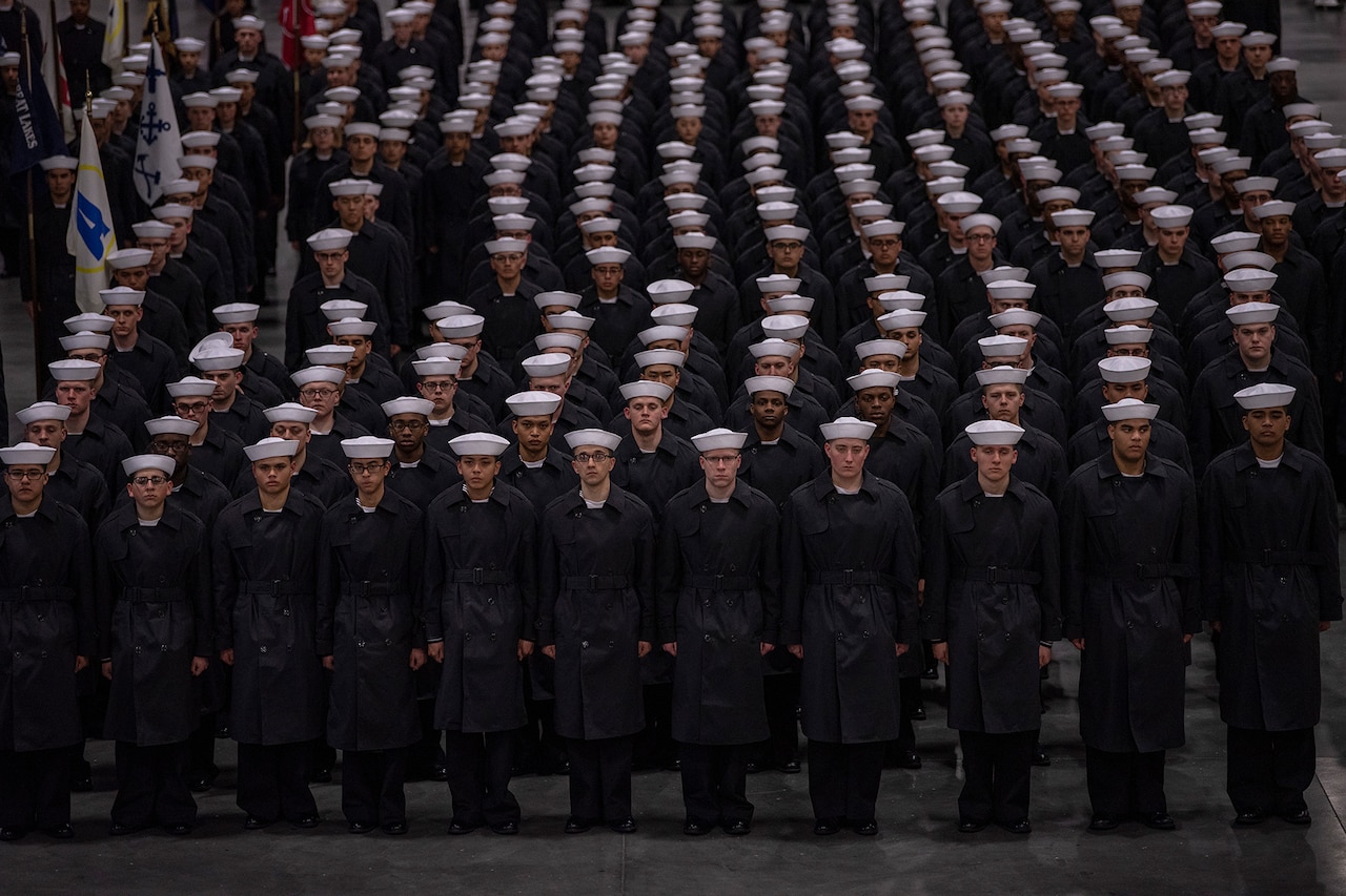 Sailors stand in formation.