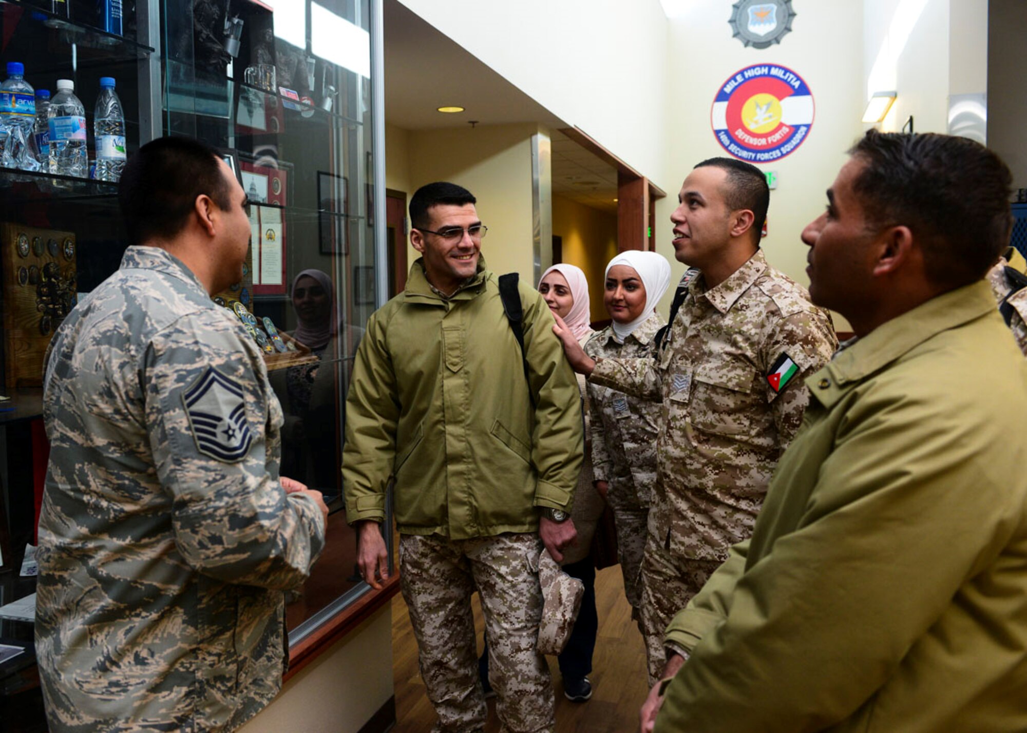 Jordanian Air Force members talking to US Airman