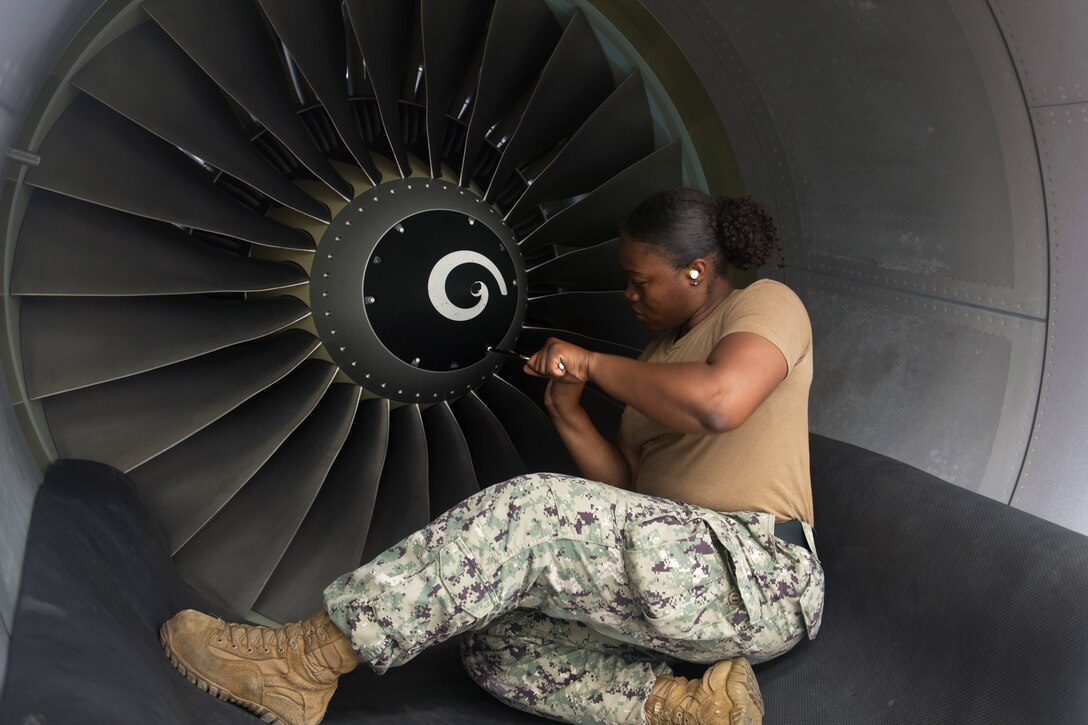 A sailor removes the rotary blade while sitting