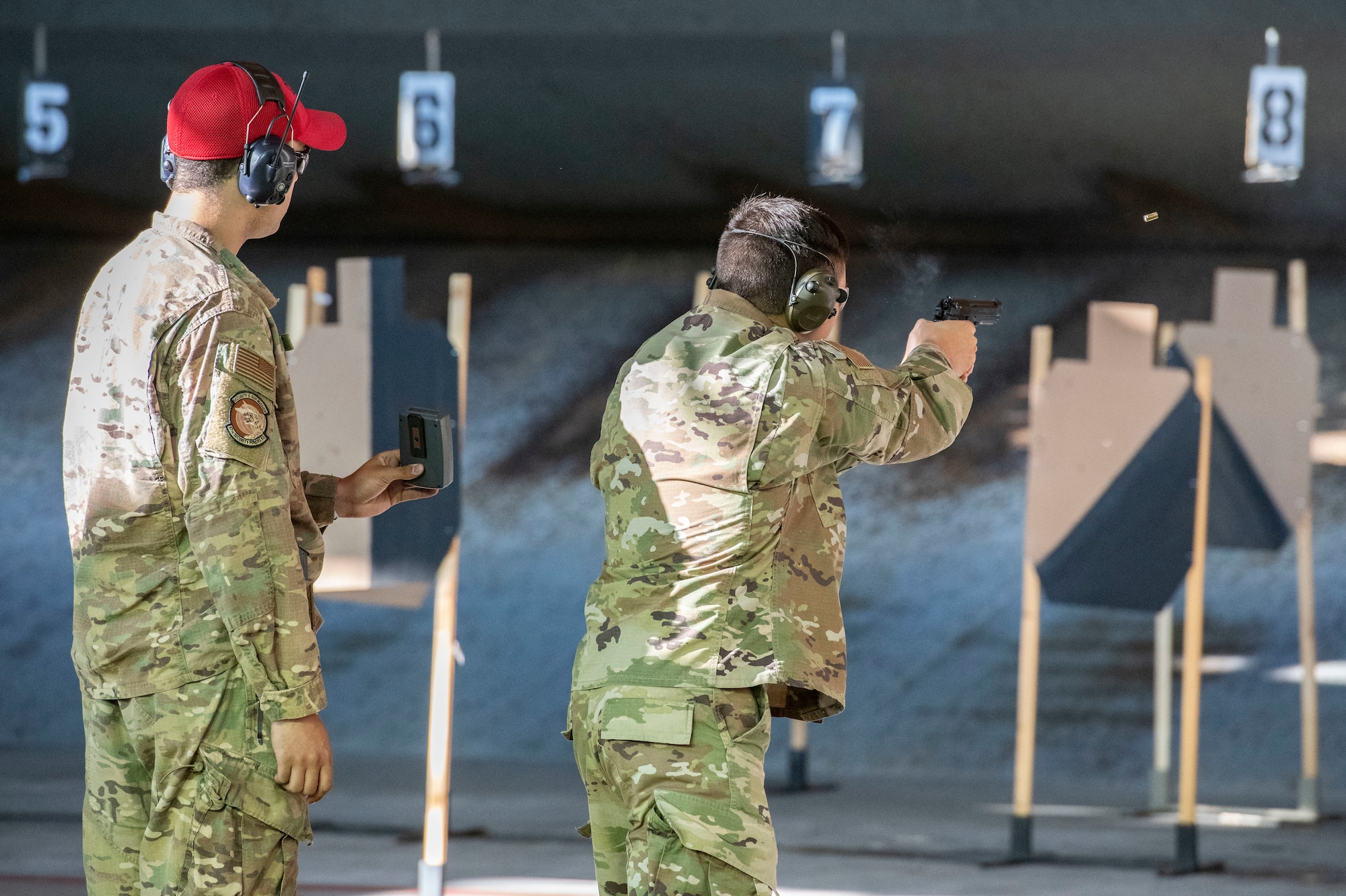 U.S. Air Force Senior Airman Noah Marsh, member of the 97th Security Forces Squadron Combat Arms Team, left, and 1st Lt. Jacob Kirkland, a 97th Contracting Flight Contracting Specialist, participate in a sheepdog shootout hosted by the 97th Security Forces Squadron, May 15, 2019, at the Altus Air Force Base Firing Range, Okla. Marsh followed all participants with a recorder and timer to ensure accurate scoring at the end of the activity. (U.S. Air Force photo by Airman 1st Class Breanna Klemm)