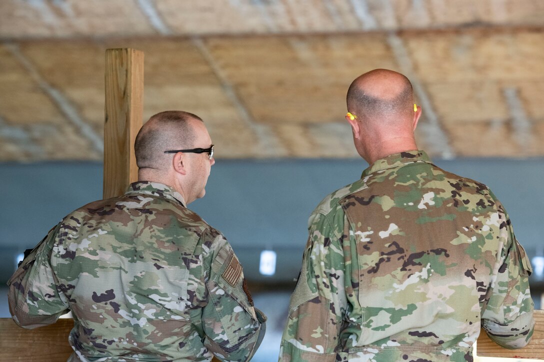 U.S. Air Force Chief Master Sgt. Anthony Burleson, 97th Security Forces Squadron Superintendent, left, and Chief Master Sergeant Randy Kay II, 97th Air Mobility Wing Command Chief, watch members of the 97th SFS participate in a sheepdog shootout in celebration of Police Week, May 15, 2019, at the Altus Air Force Base Firing Range, Okla. This event invited active duty members to join teams and compete against each other in morale and skill building activities. (U.S. Air Force photo by Airman 1st Class Breanna Klemm)