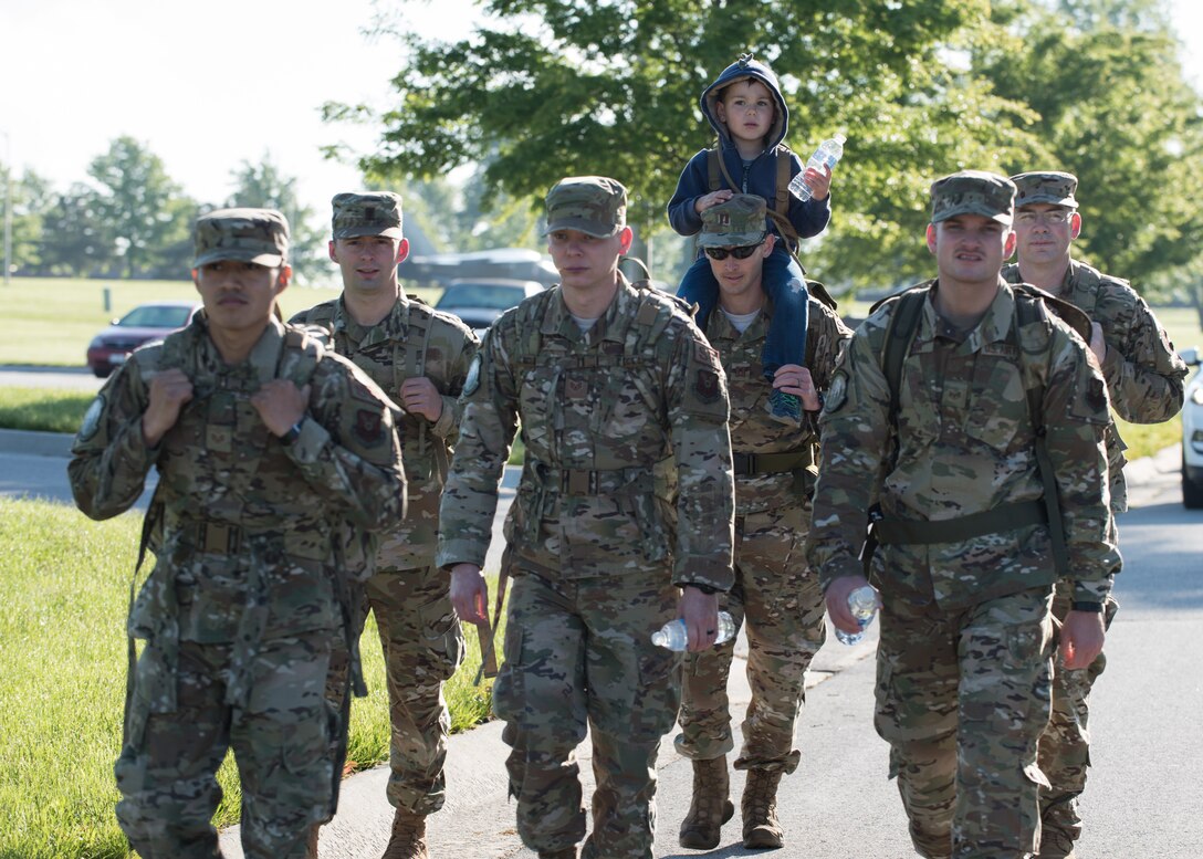 Capt. Daniel Merkh, the director of operations with the 509th Security Forces Squadron, carries his son Ben during a ruck march alongside other defenders with the 509th SFS on May 13, 2019, at Whiteman Air Force Base, Missouri.