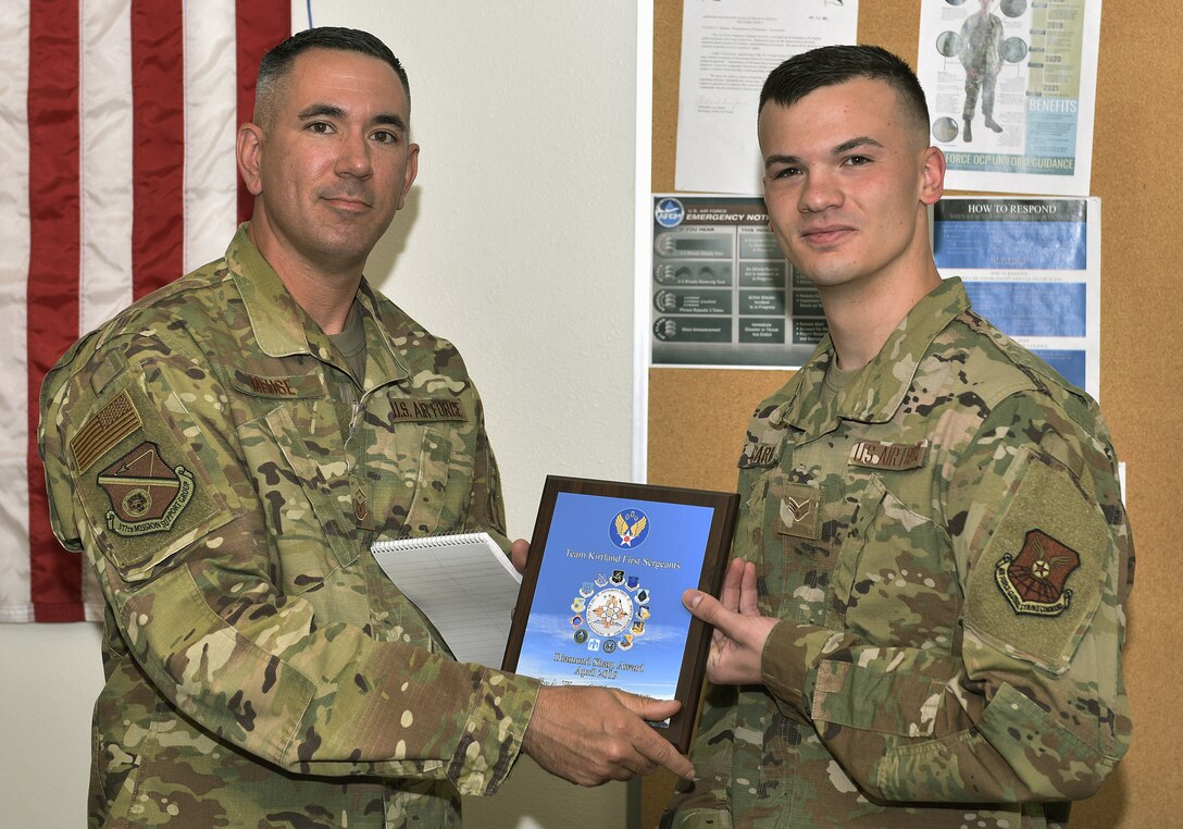 Senior Airman Kendell Carver, 377th Maintenance Squadron, receives the April Diamond Sharp award from Master Sgt. Jason Meuse, 377th Logistics Readiness Squadron first sergeant, at Kirtland May 15, 2019. Carver performed duties normally carried out by NCO’s in the munitions accountability, munitions control and munitions plans and scheduling sections. As a 58th Special Operations Wing liaison, Carver organized the delivery of 78,000 7.62mm, .50 caliber and M206 flare countermeasure assets. He calculated munitions requirements, scheduled pre-flight munitions inspections, published work orders and physically delivered assets on multiple occasions. Carver’s efforts enabled 48 live-fire sorties, allowing for 240 hours of combat search and rescue training. (U.S. Air Force photo by Airman 1st Class Austin J. Prisbrey)