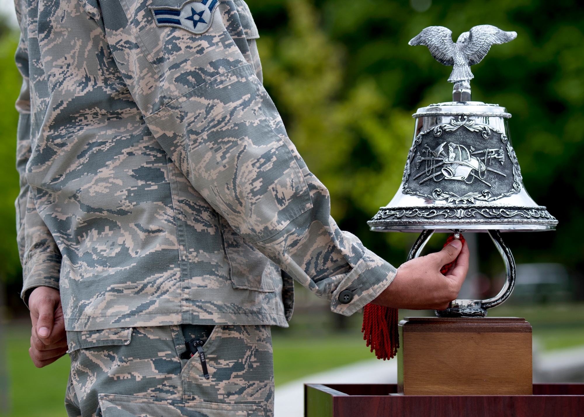 U.S. Air Force Airman 1st Class Ponce Francisco, 92nd Security Forces Squadron installation entry controller, rings a bell in remembrance of fallen law enforcement officers during a National Police Week Memorial Retreat Ceremony at Fairchild Air Force Base, Washington, May 15, 2019. The law enforcement community is honored annually with numerous events after President John F. Kennedy signed a proclamation in 1962 to designate May 15 as Peace Officers Memorial Day and the week as National Police Week. (U.S. Air Force photo by Airman 1st Class Whitney Laine)