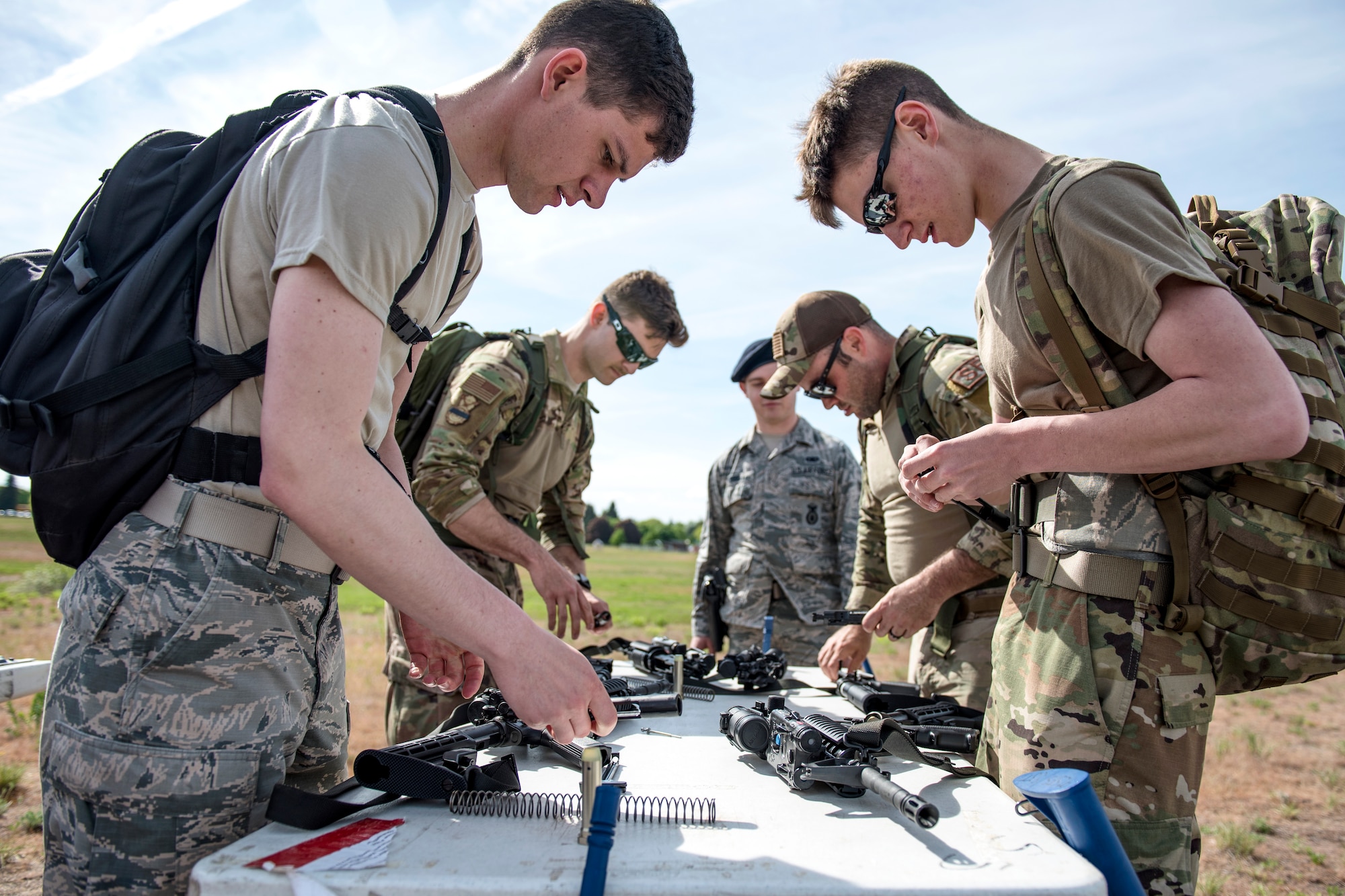 Airmen from the 92nd Security Forces Squadron compete in the Defender Challenge during National Police Week at Fairchild Air Force Base, Washington, May 16, 2019. The challenge included a timed 3 mile ruck, a Humvee push and a litter carry. (U.S. Air Force photo by Airman 1st Class Whitney Laine)