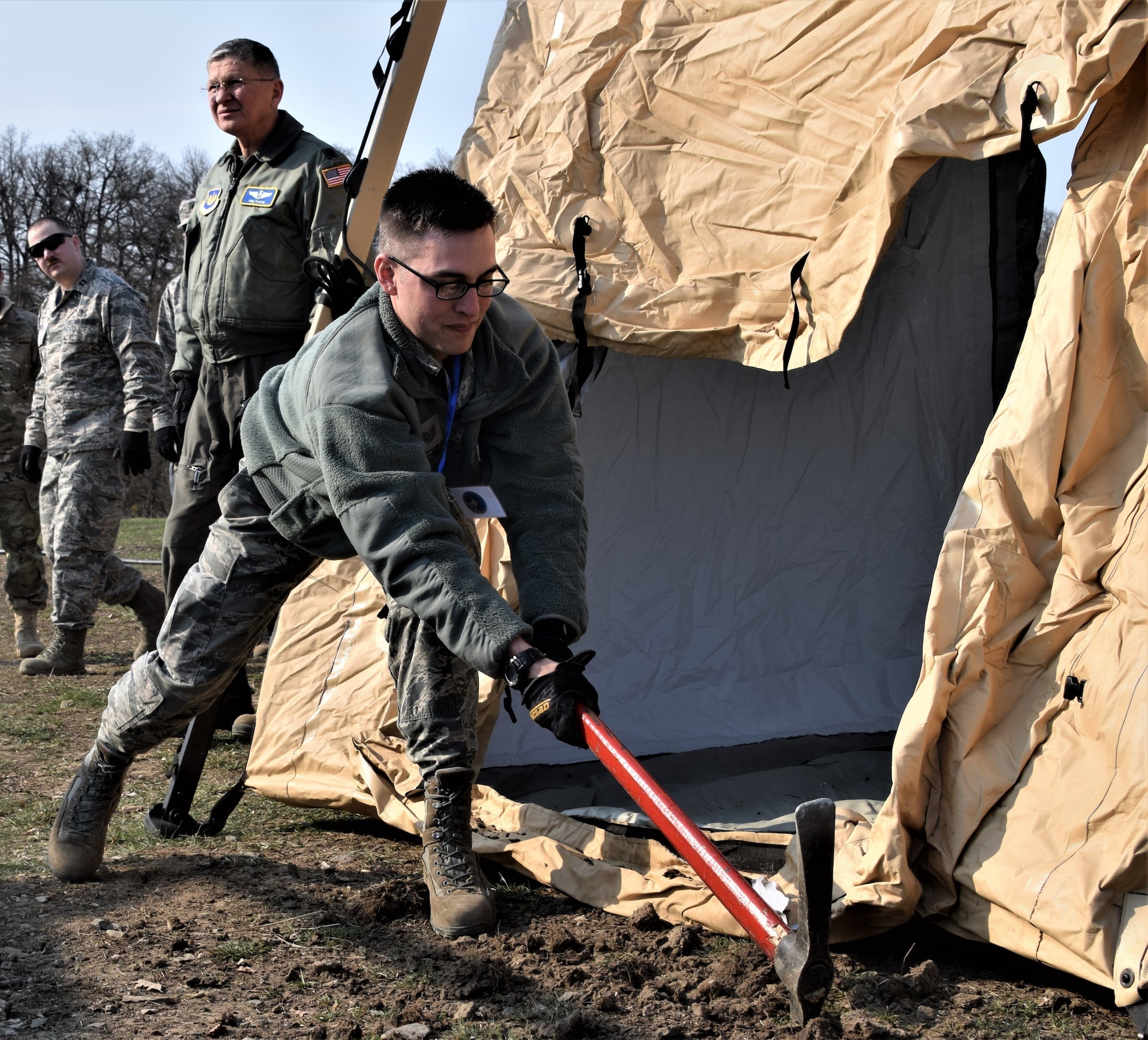Tech. Sgt. Christopher Sarchioto, 86th Medical Group, Ramstein Air Base Germany, prepares an expeditionary medical support system (EMEDS) at Cincu Military Base, Romania, April 4, 2019, during exercise Vigorous Warrior 19. EMEDS are modular field hospitals designed to be deployed and fully operational within six hours of arrival in an area of responsibility. (U.S. Air Force photo illustration)