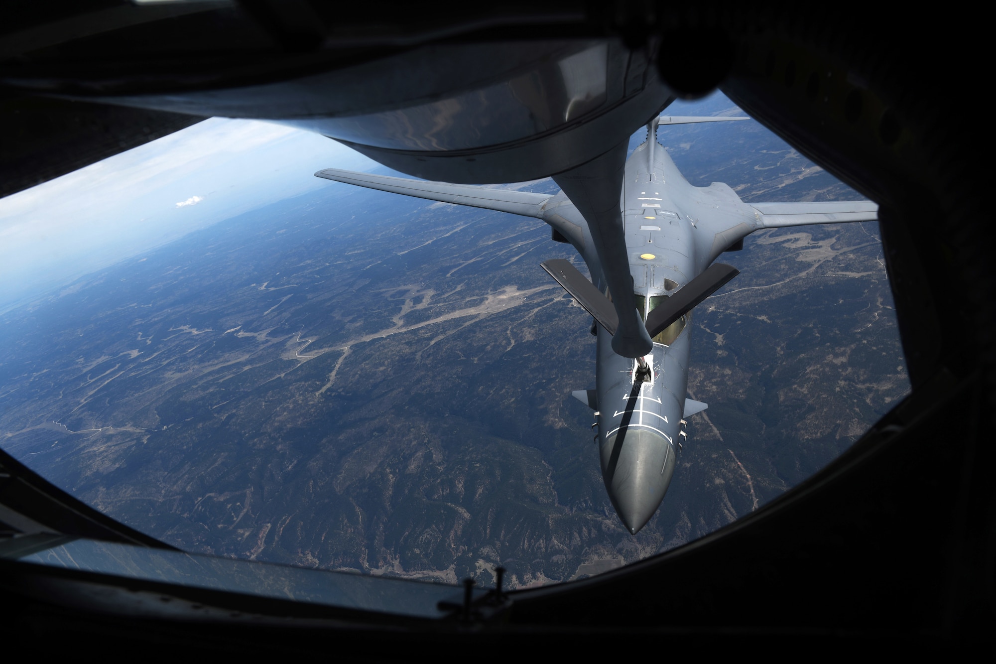 A B-1B Lancer is refueled during Combat Raider 19-2 by a KC-135 Stratotanker above Wyoming on May 15, 2019. Combat Raider is a large-force exercise hosted by the 28th Bomb Wing at Ellsworth Air Force Base, S.D., where service members receive valuable training that can be used in a deployed environment. (U.S. Air Force photo by Senior Airman Thomas Karol)