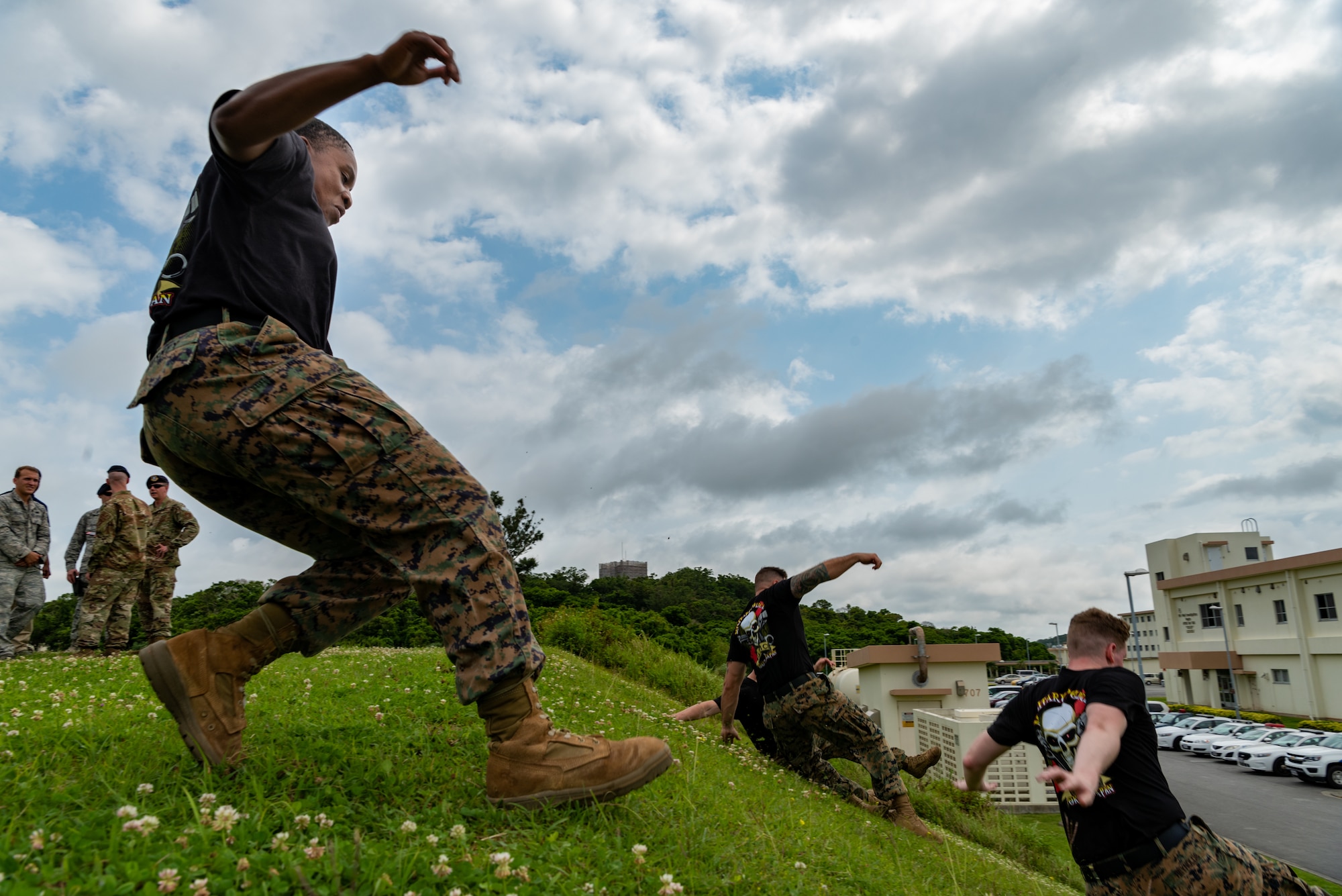 U.S. Marine Corps Staff Sgt. Nivia Huskey, Provost Marshal's Office military police officer, jumps a hill during the physical portion of the Shogun Challenge for the 2019 Police Week May 14, at Kadena Air Base, Japan.