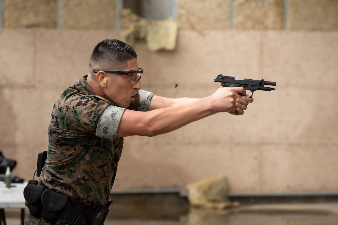 A U.S. Marine assigned to the Provost Marshal Office, fires an M9 pistol during a stress fire competition May 17, 2019, at Kadena Air Base, Japan.
