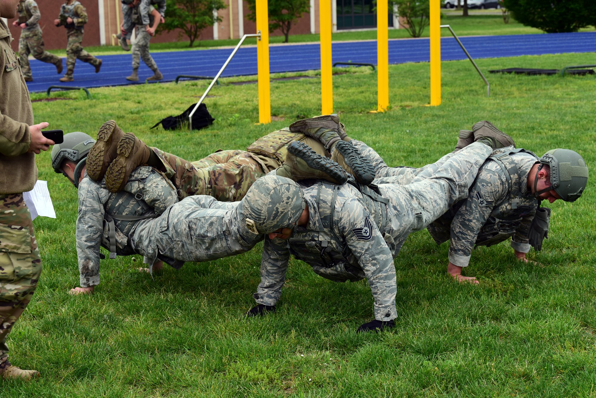 31st Security Forces Squadron Airmen engage in a square pushup to build teamwork during the Police Week Combat Challenge held May 15, 2019 at Aviano Air Base, Italy. The combat challenge was the first event of the 2019 Joint International Non Commissioned Officer course Development Course. (U.S. Air Force photo by Airman 1st Class Caleb House)