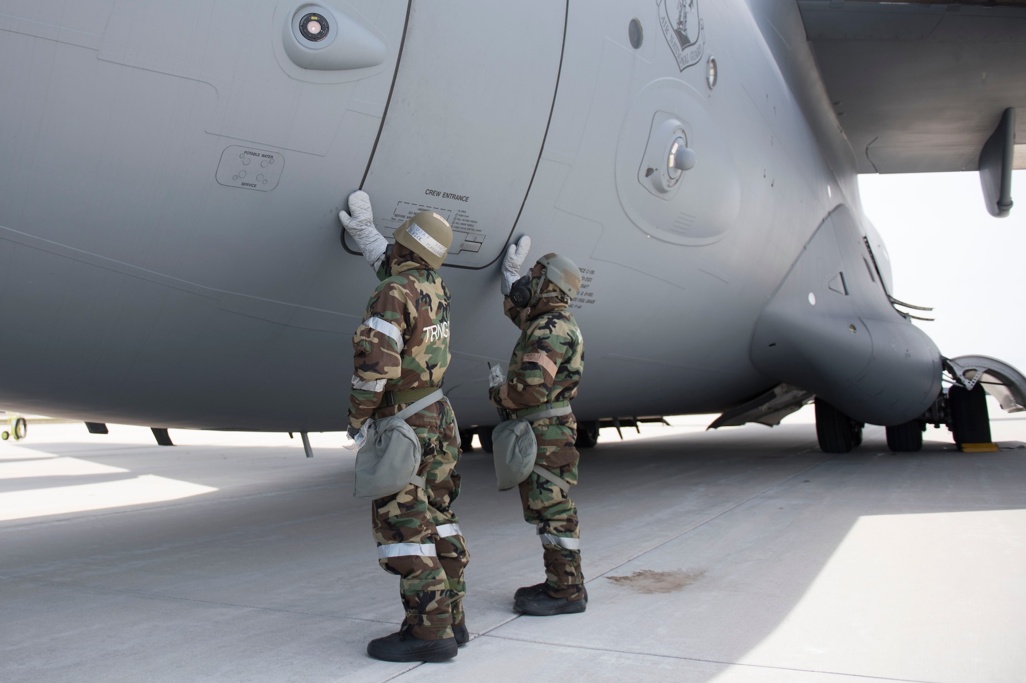 167th Airlift Wing aircraft maintainers simulate decontaminating a crew entrance door on a C-17 aircraft during a training exercise at Alpena Combat Readiness Training Center, Alpena, Mich., May 8, 2019. Approximately 300 167th AW Airmen participated in the training event. (U.S. Air National Guard photo by Tech. Sgt. Jodie Witmer)