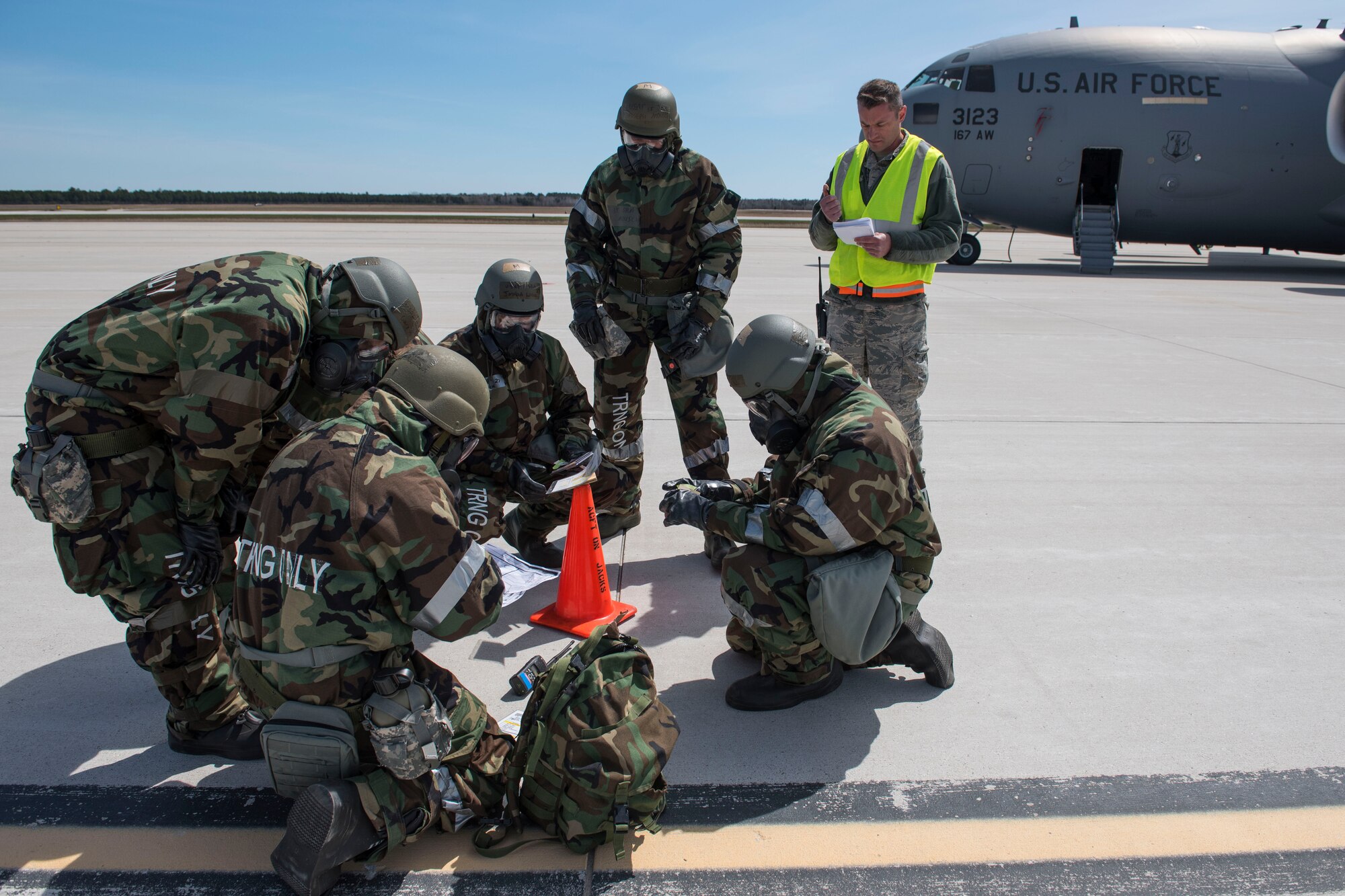 167th Airlift Wing aircraft maintainers access contamination on the flight line during a during a training exercise at Alpena Combat Readiness Training Center, Alpena, Mich., May 8, 2019. Approximately 300 167th AW Airmen participated in the training event. (U.S. Air National Guard photo by Senior Master Sgt. Emily Beightol-Deyerle)