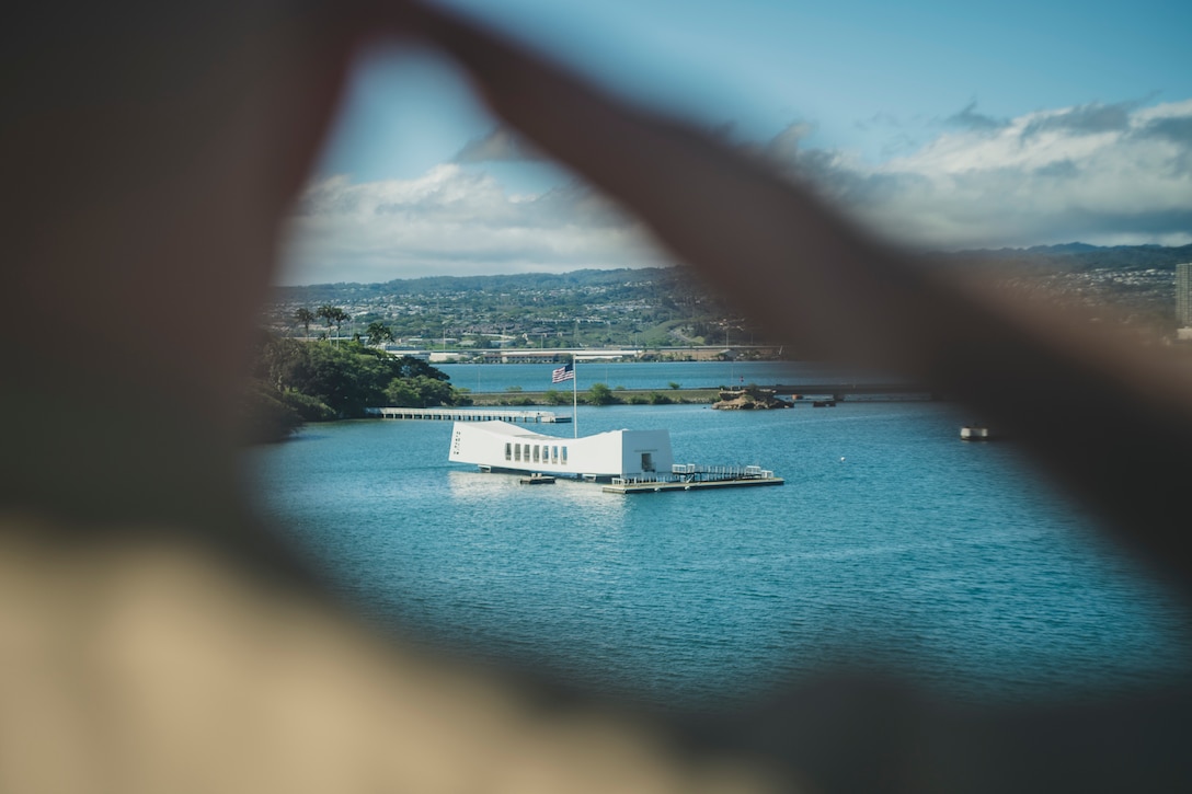190514-M-HB658-0083 PEARL HARBOR, HAWAII A U.S. Marine with the 11th Marine Expeditionary Unit salutes the USS Arizona memorial while manning the rails of the San Antonio-class amphibious transport dock ship USS John P. Murtha. The Marines and Sailors of the 11th MEU are conducting routine operations as part of the Boxer Amphibious Ready Group.