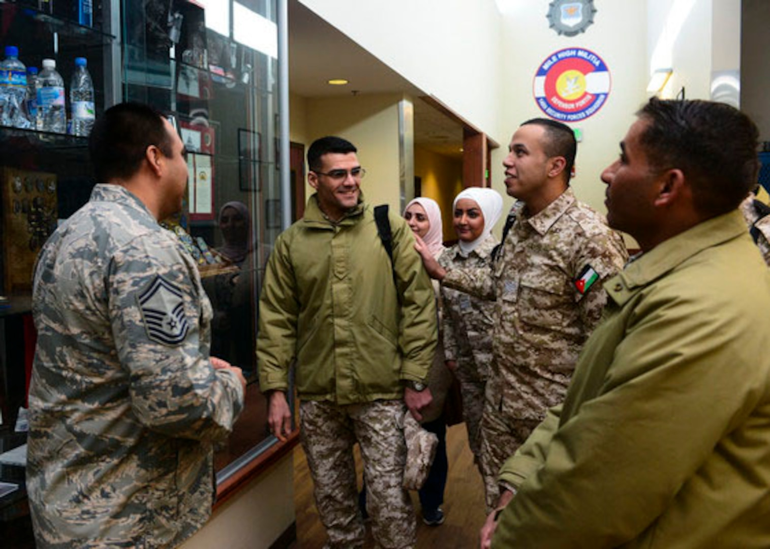U.S. Air Force Senior Master Sgt. Jose Alfaro, 140th Wing Security Forces, Colorado Air National Guard, escorts members of the Royal Jordanian Air Force on a tour of the Chief Warrant Officer 5 Dave Carter Army Aviation Support Facility at Buckley Air Force Base, Aurora, Colorado, Feb. 5, 2019. The meeting between Jordanians and senior enlisted leaders aimed to foster strong relationships between forces as well as enhance Jordanian enlisted policy and practices. Jordan and Colorado have been partners since 2004.