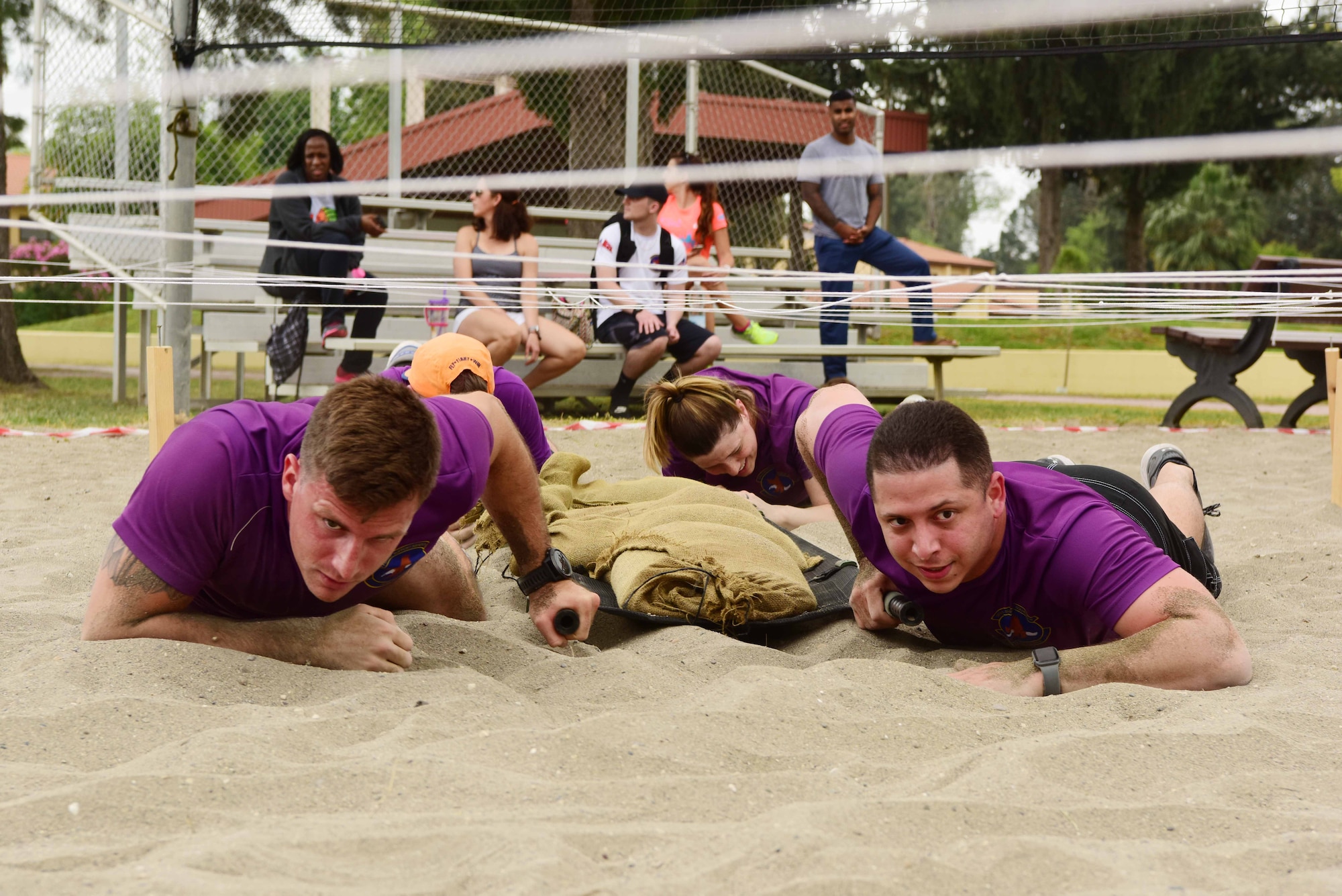 Members of the 39th Force Support Squadron perform a litter carry while low crawling during the Titan Medic Games May 11, 2019, at Incirlik Air Base, Turkey. The litter carry challenge tested teams’ ability to transport patients under hostile conditions. (U.S. Air Force photo by Tech. Sgt. Jim Araos)