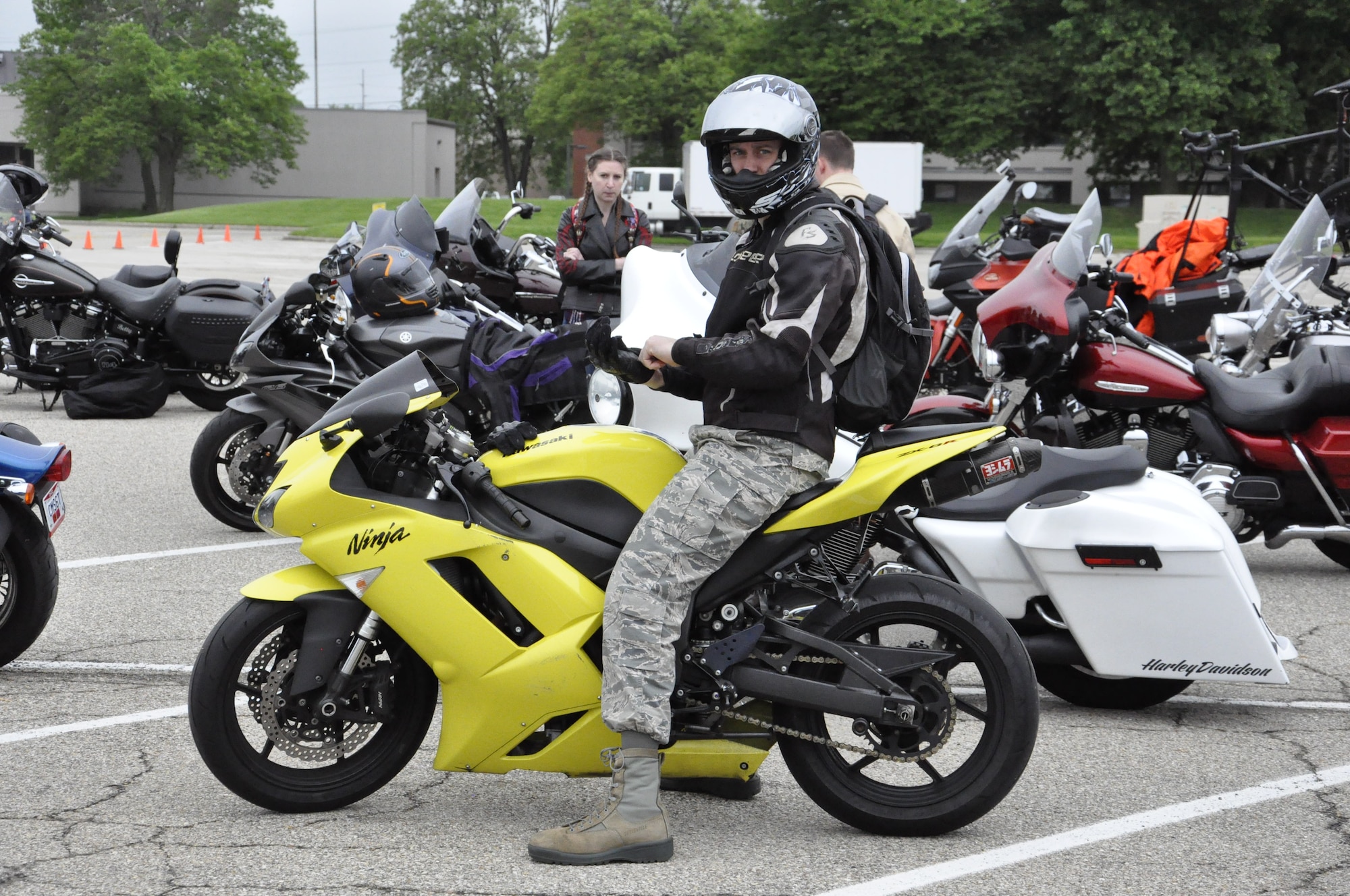Capt Ryan Watson pulls on his safety gloves and gets ready before he prepares to participate in the group mentorship ride May 10.