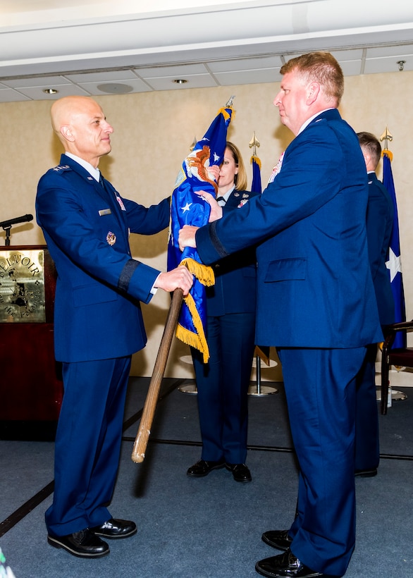 Brig. Gen. Terry L Bullard accepts the Air Force Office of Special Investigations flag from Lt. Gen. Sami D. Said, The Inspector General of the Air Force, during AFOSI's Change of Command Ceremony, May 16, 2019. General Bullard is the 19th Commander in the 70-year history of AFOSI. (U.S. Air Force photo by Mr. Michael Hastings)