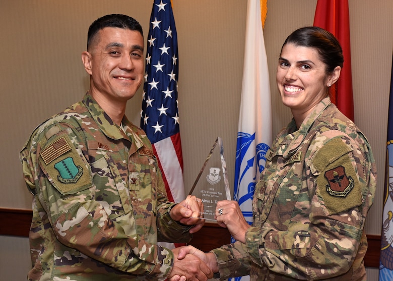 Col. Ricky Mills, 17th Training Wing Commander, presents the Air Education and Training Command Command Post Noncommissioned Officer the Year award to Tech. Sgt. Aimee Thomas, 17th Training Wing CP Command and Control Operations NCO in charge, at Goodfellow Air Force Base, Texas, May 14, 2019. It's the job of Command Post specialists to ensure operations and communications run efficiently and effectively under any circumstance. (U.S. Air Force photo by Senior Airman Seraiah Hines)