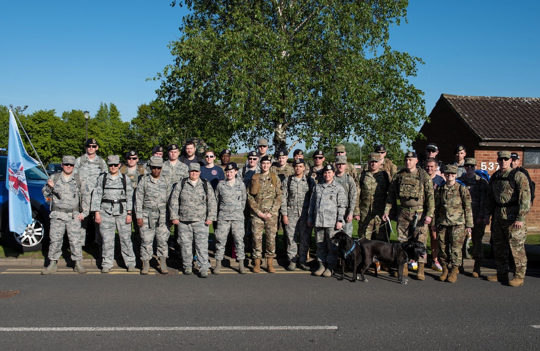 U.S. Air Force members of the 423rd Security Forces Squadron pose for a group photo at the Police Week Kick-Off 5K and Memorial Ruck, May 13, 2019, RAF Alconbury, England. During Police Week law enforcement officers from around the world participate in events to honor those who paid the ultimate sacrifice. (U.S. Air Force photo by Airman 1st Class Jennifer Zima)