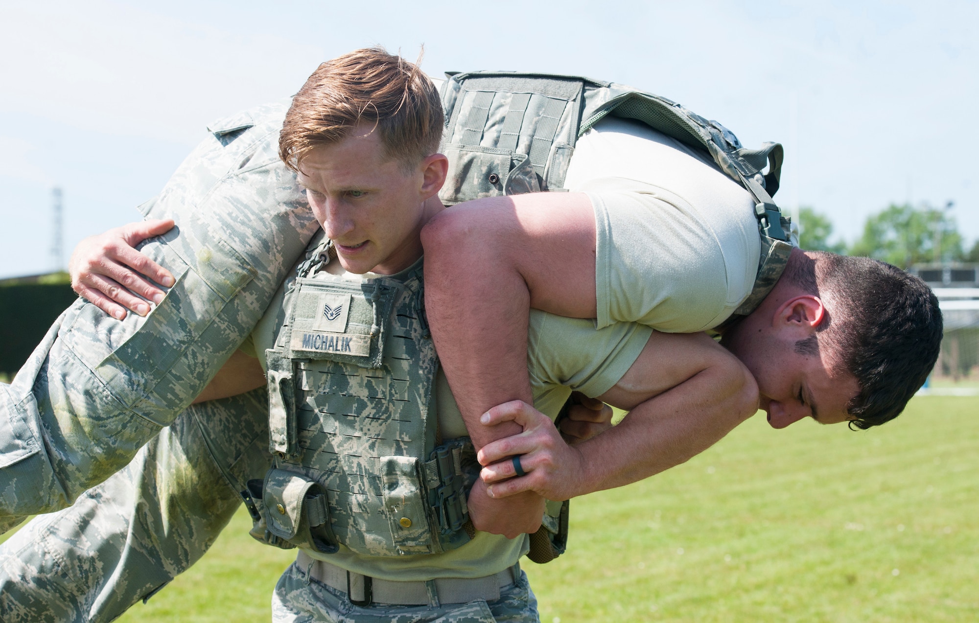 U.S. Air Force Staff Sgt. Shane Michalik, a defender with the 423rd Security Forces Squadron, carries another Airman during a Police Week Defenders Challenge at RAF Alconbury, England on May 15, 2019. Police Week occurs each year across the peace officer community as a way of remembrance of those that have served in law enforcement and those that paid have the ultimate sacrifice. (U.S. Air Force photo by MSgt. Brian Kimball)