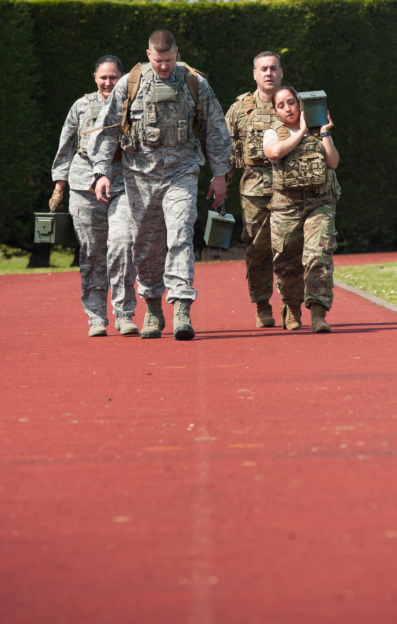 U.S. Air Force Defenders with the 423rd Security Forces Squadron, carry ammo cans and a ruck as a four person team during a Police Week Defenders Challenge at RAF Alconbury, England on May 15, 2019. Police Week occurs each year across the peace officer community as a way of remembrance of those that have served in law enforcement and those that paid have the ultimate sacrifice. (U.S. Air Force photo by MSgt. Brian Kimball)