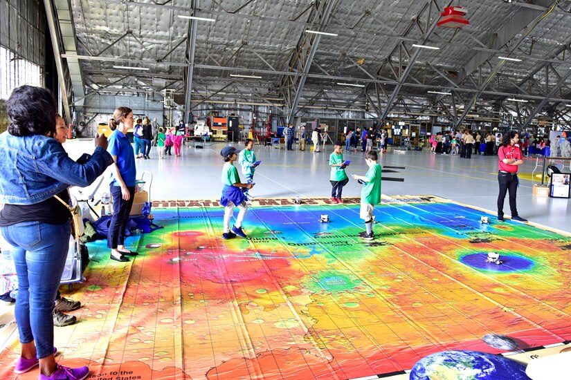 Attendees of the Legends in Flight Joint Base Andrews Air and Space Expo 2019 look at various set-ups in the Science Technology Engineering and Math hangar on JB Andrews, Md., May 10, 2019. More than 7,000 local students came out to participate in various activities in the STEM hangars. (U.S. Air Force photo by Airman 1st Class Noah Sudolcan)