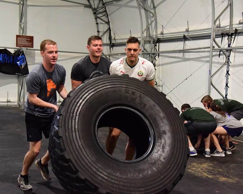 Team members flip a tire during the A-BLAZIN’ Race May 10, 2019, on Columbus Air Force Base, Miss. Similar to the challenges in the international game show, the “Amazing Race”, teams raced against each other in a competition to see who could complete the stationed challenges in the shortest amount of time. (U.S. Air Force photo by Elizabeth Owens)